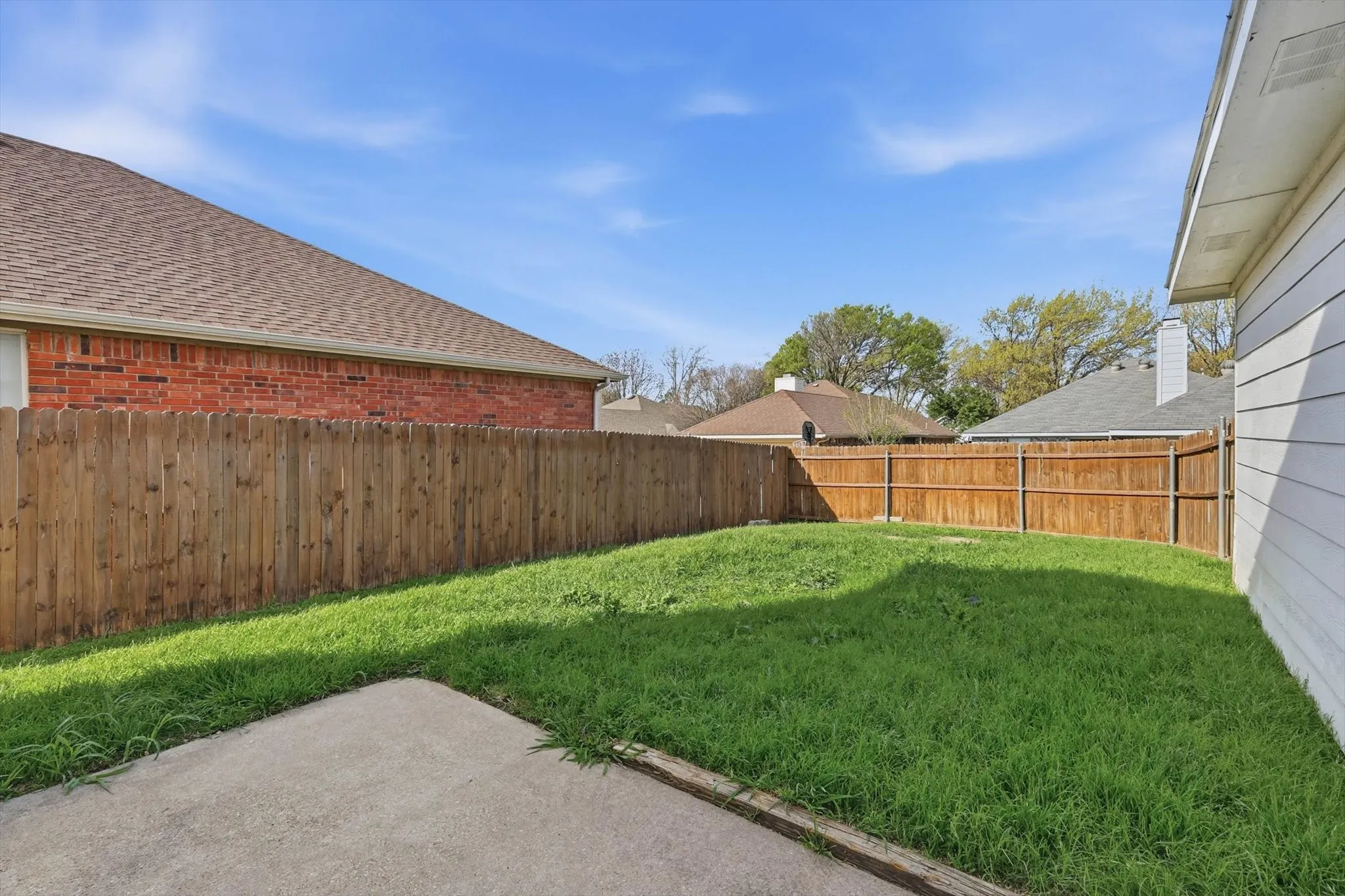 Fenced backyard featuring a patio area