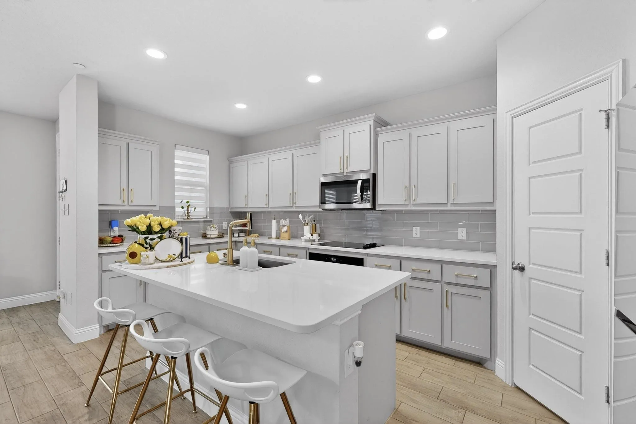 Big island workspace with walk-in pantry steps away
