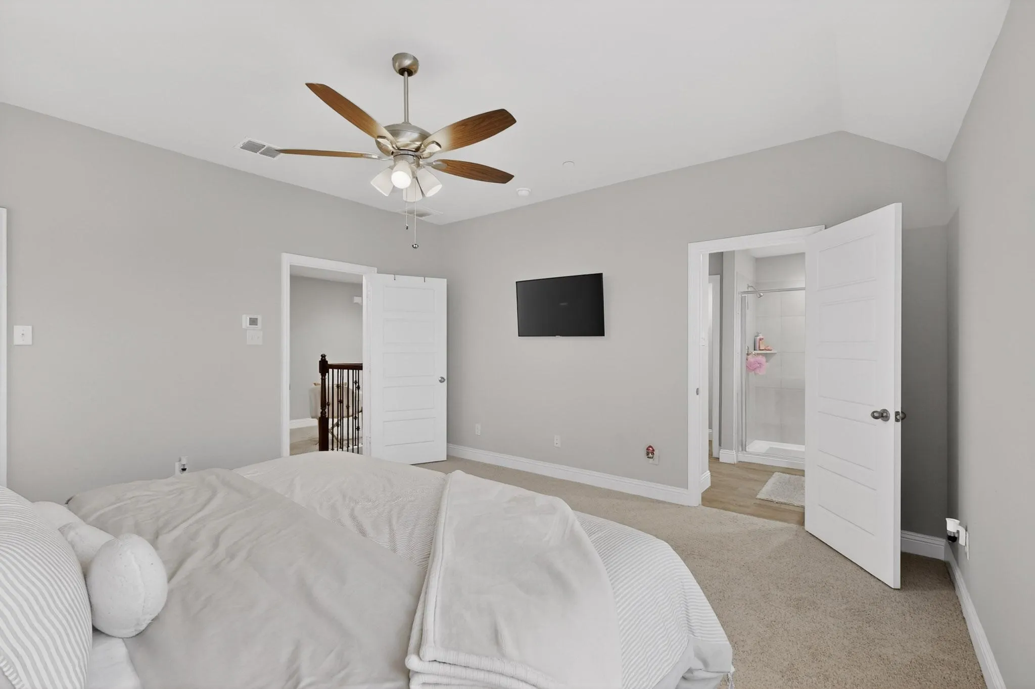 Secondary bedroom with fan and soft carpet