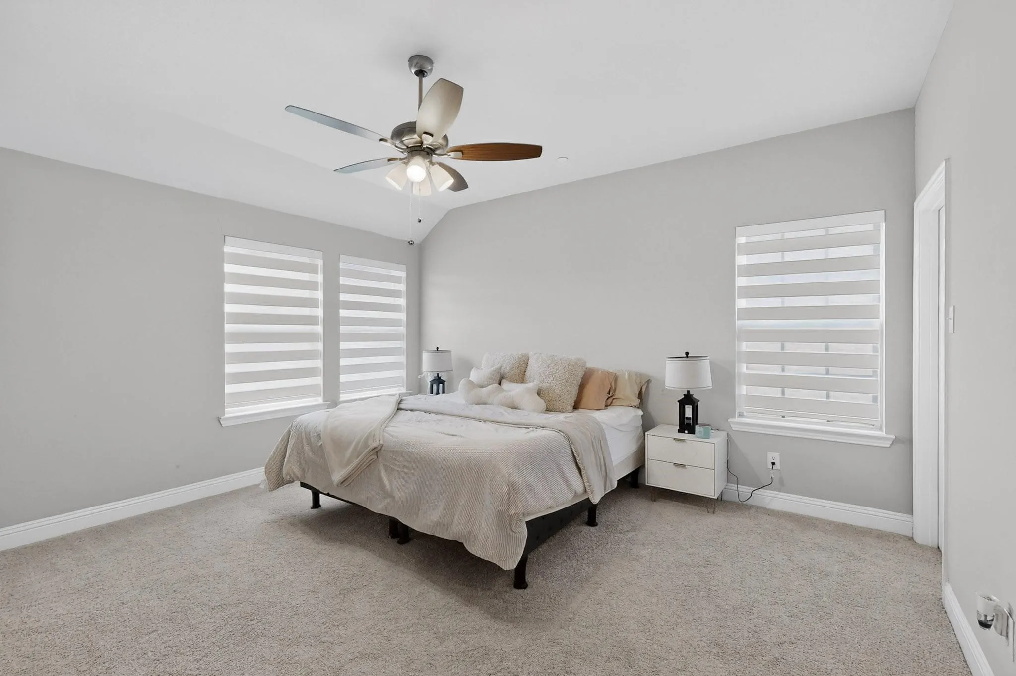 Carpeted bedroom with ceiling fan