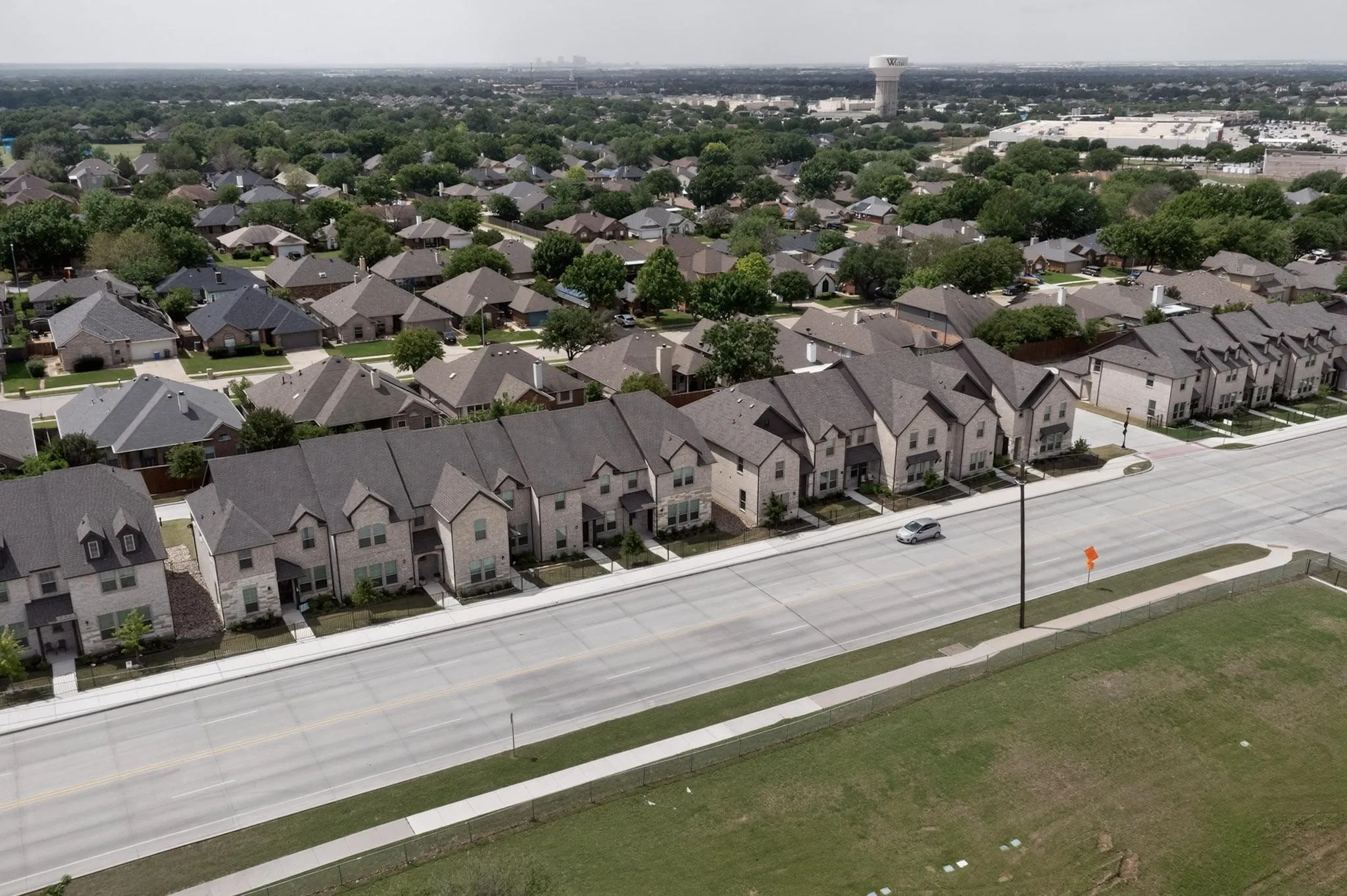 Aerial: newer townhome row with rear-entry garages
