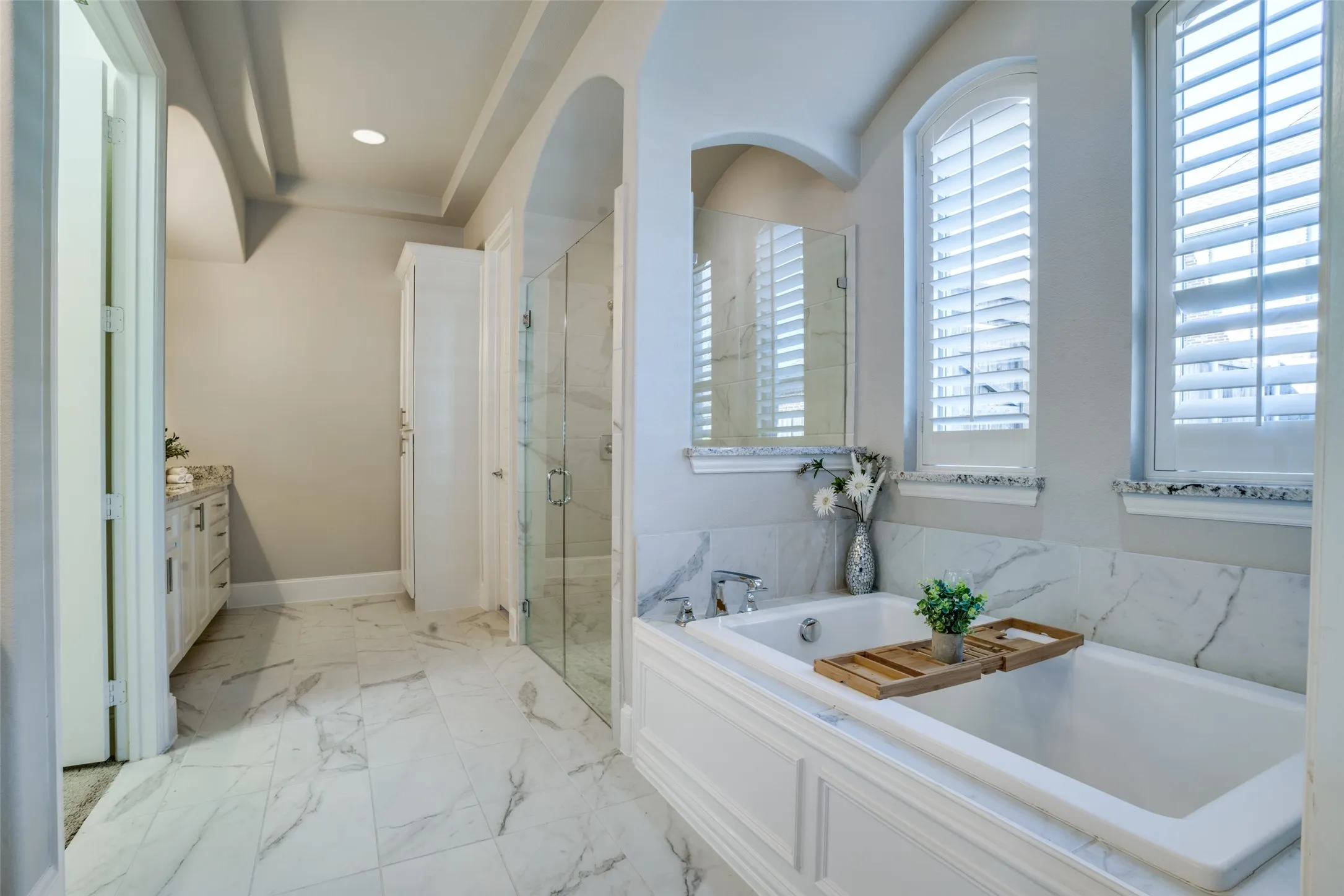 Primary bathroom with recessed lighting, a large shower, and a soaking tub