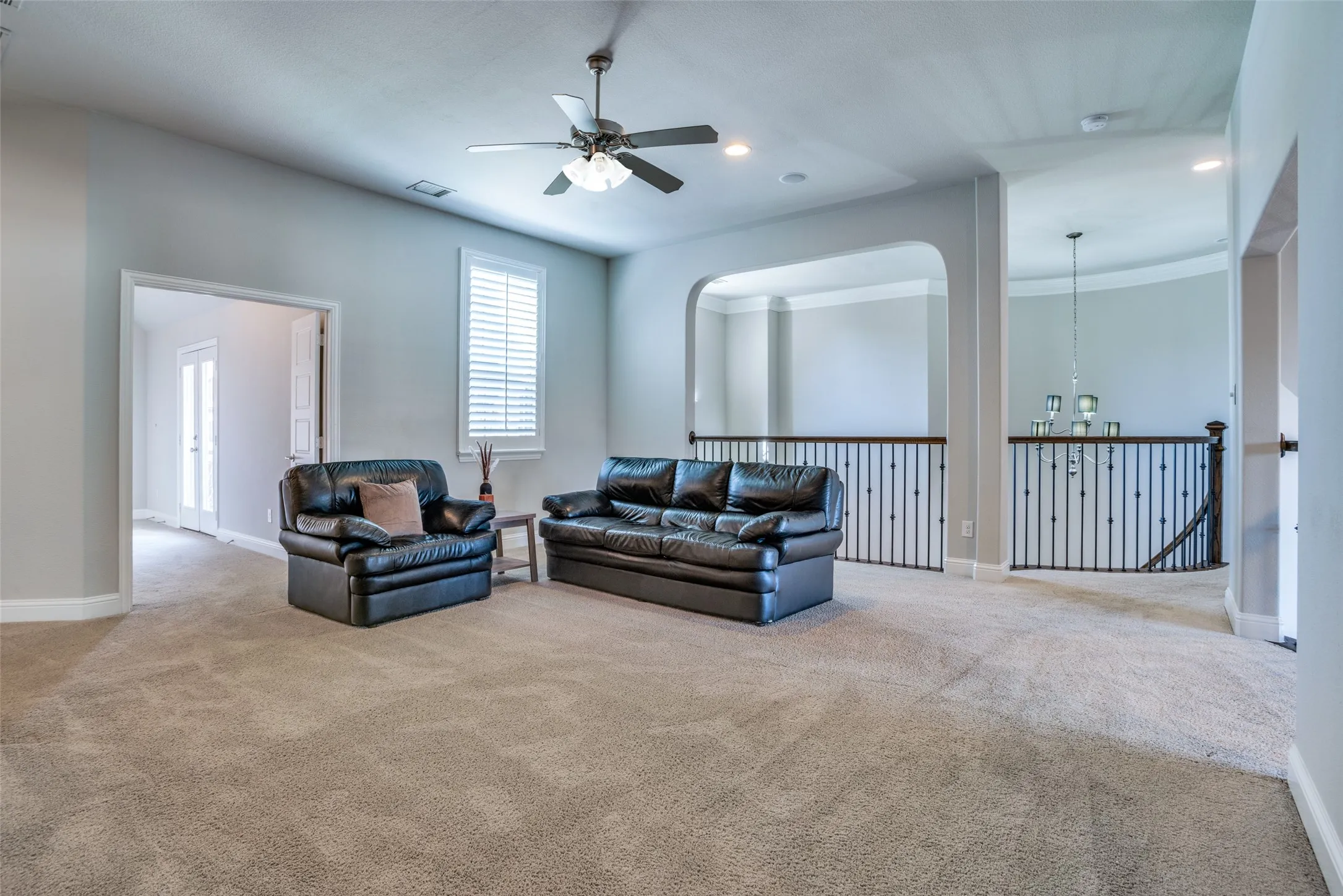Upstairs big game room with ceiling fan