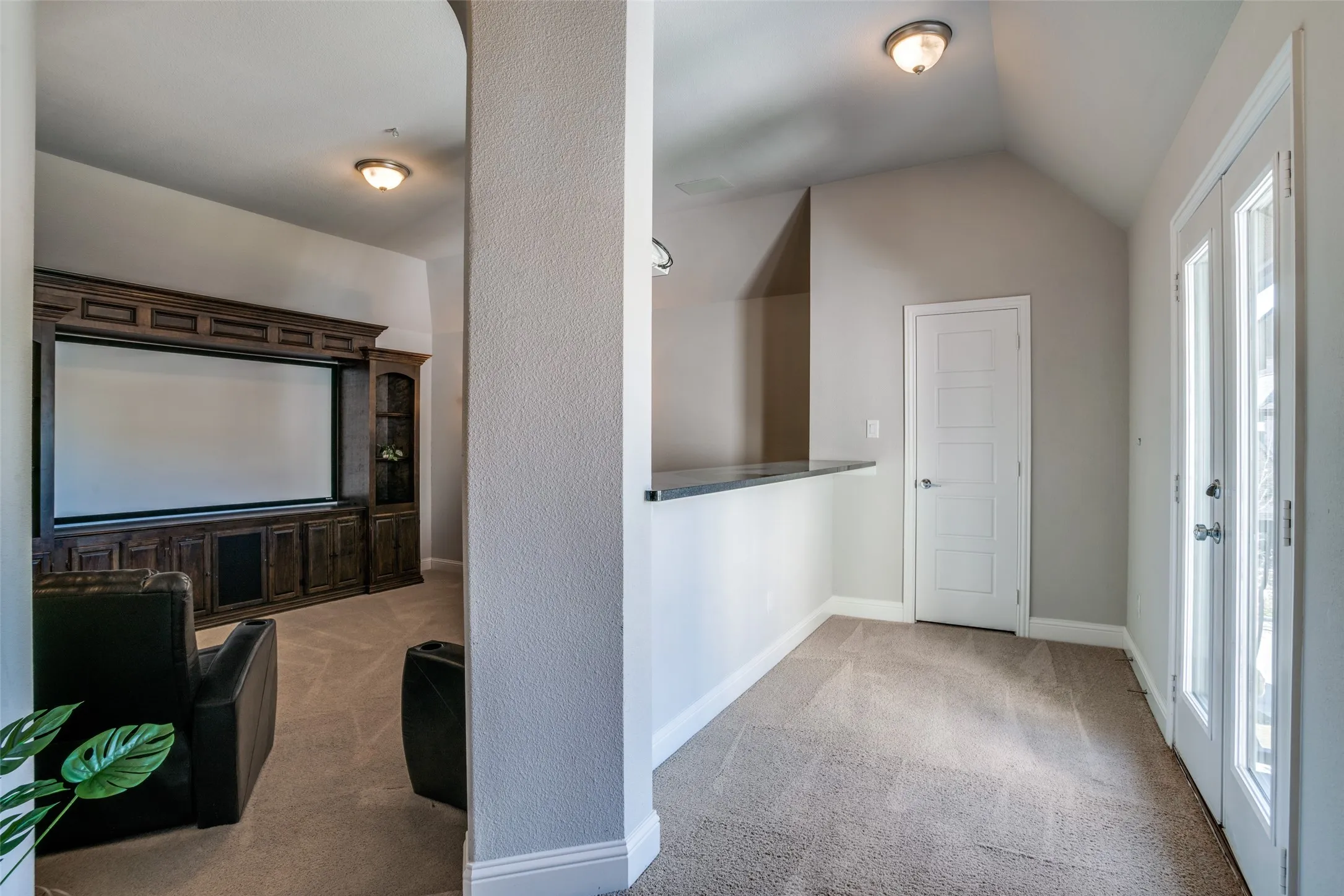 Media room with a serving bar or an eating bar with doors to the outside Juliette balcony