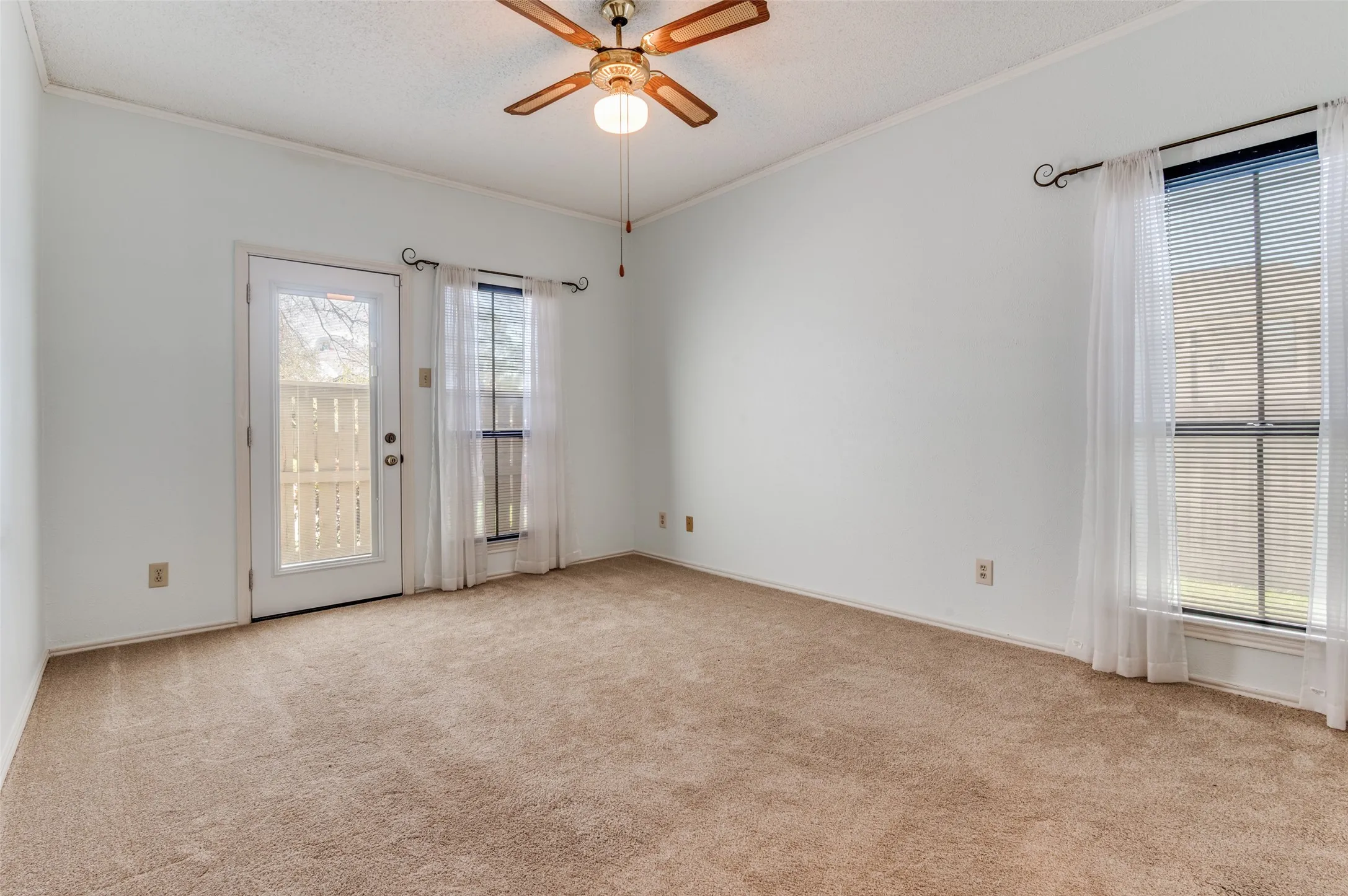 Primary bedroom with access to second patio & a walk-in closet