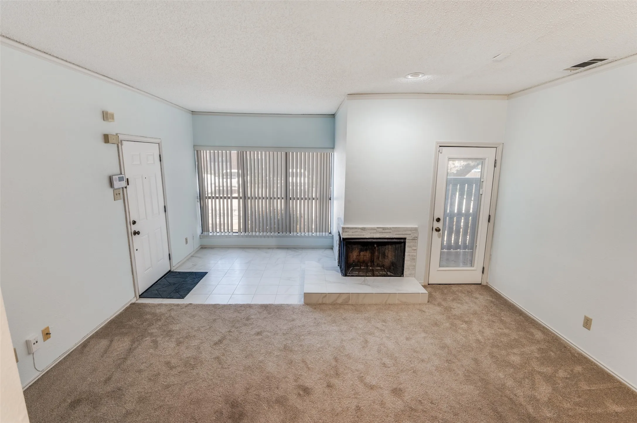 Open layout to dining room with 2 sided wood burning fireplace