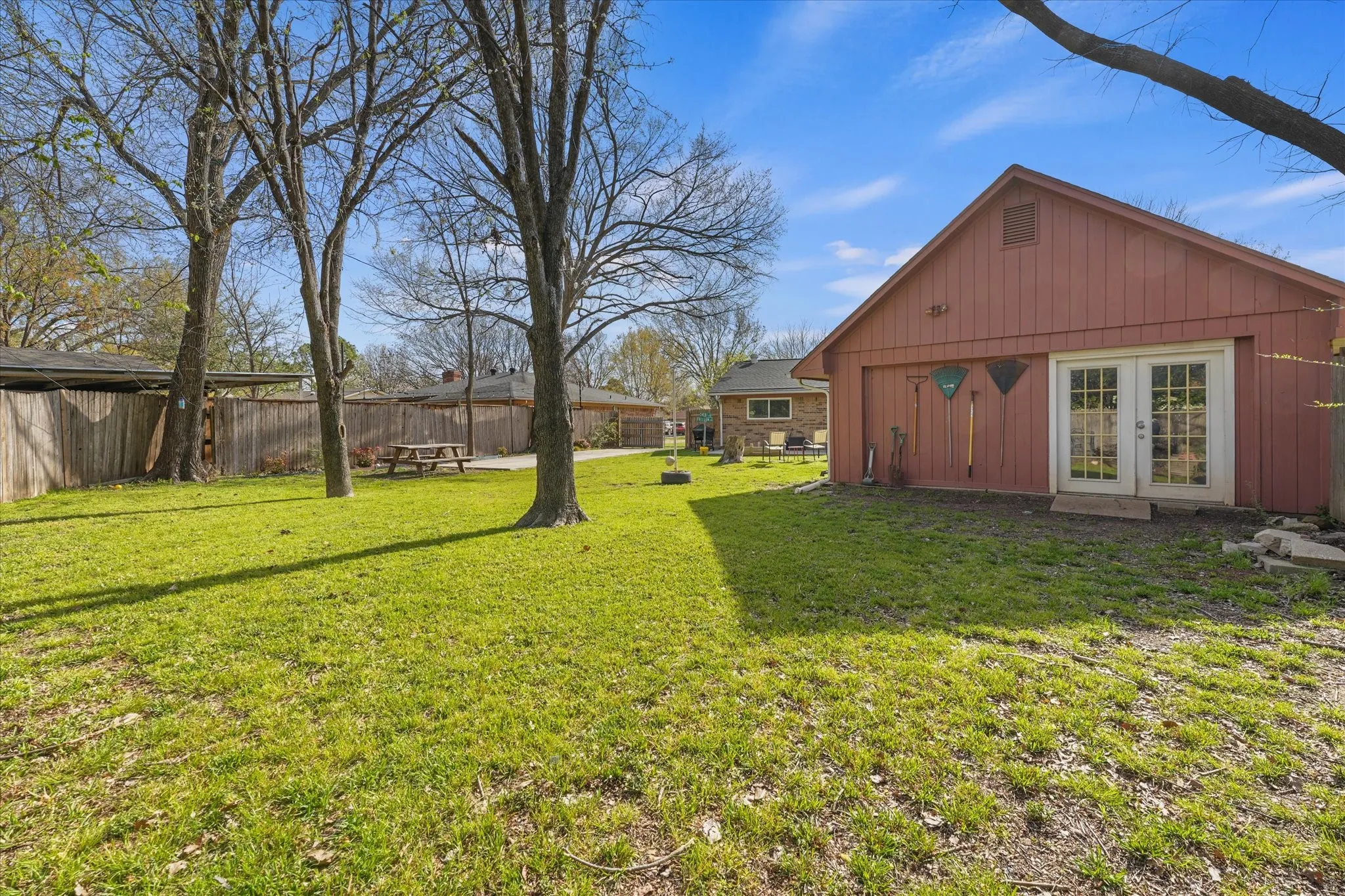 Expansive yard with detached workshop/storage building—perfect for hobbies, tools, or additional storage. Great setup for buyers needing extra functional space.