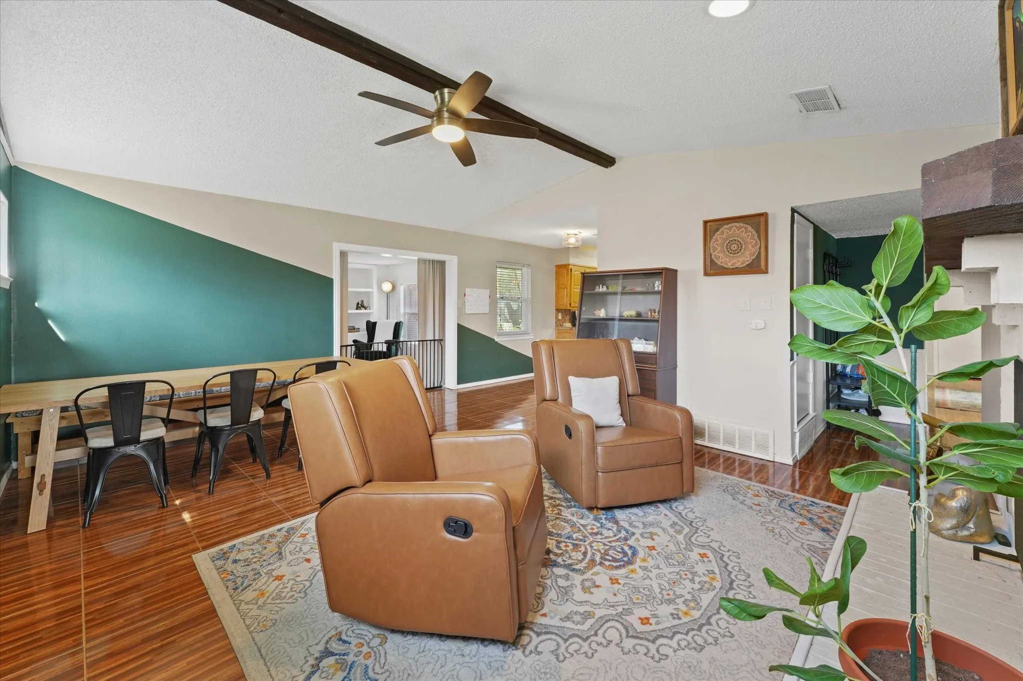 Open-concept living and dining areas with flexible layout options and vaulted ceiling detail.