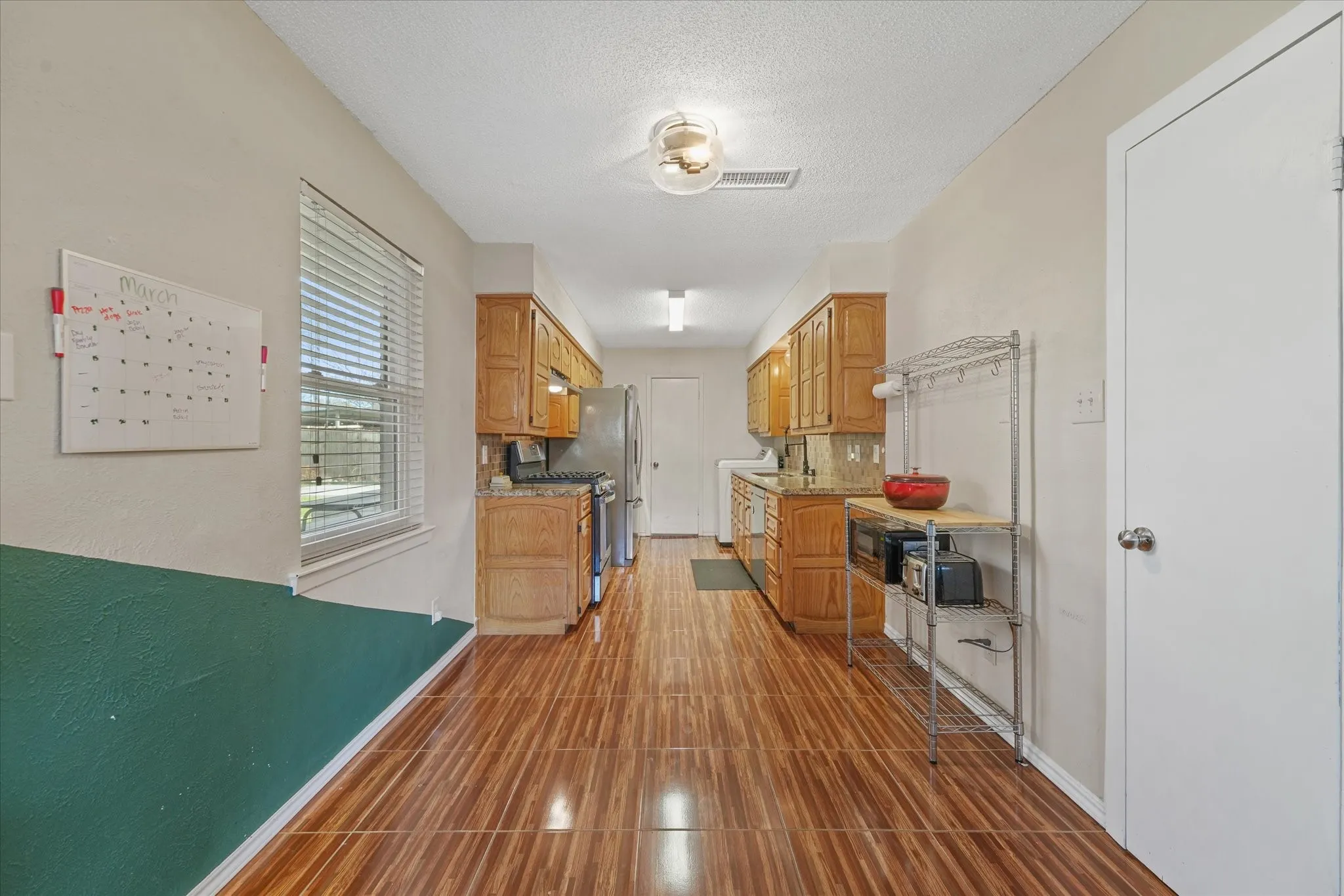 Bright kitchen with natural light, extended counter space, and functional layout—ideal for everyday cooking and entertaining.