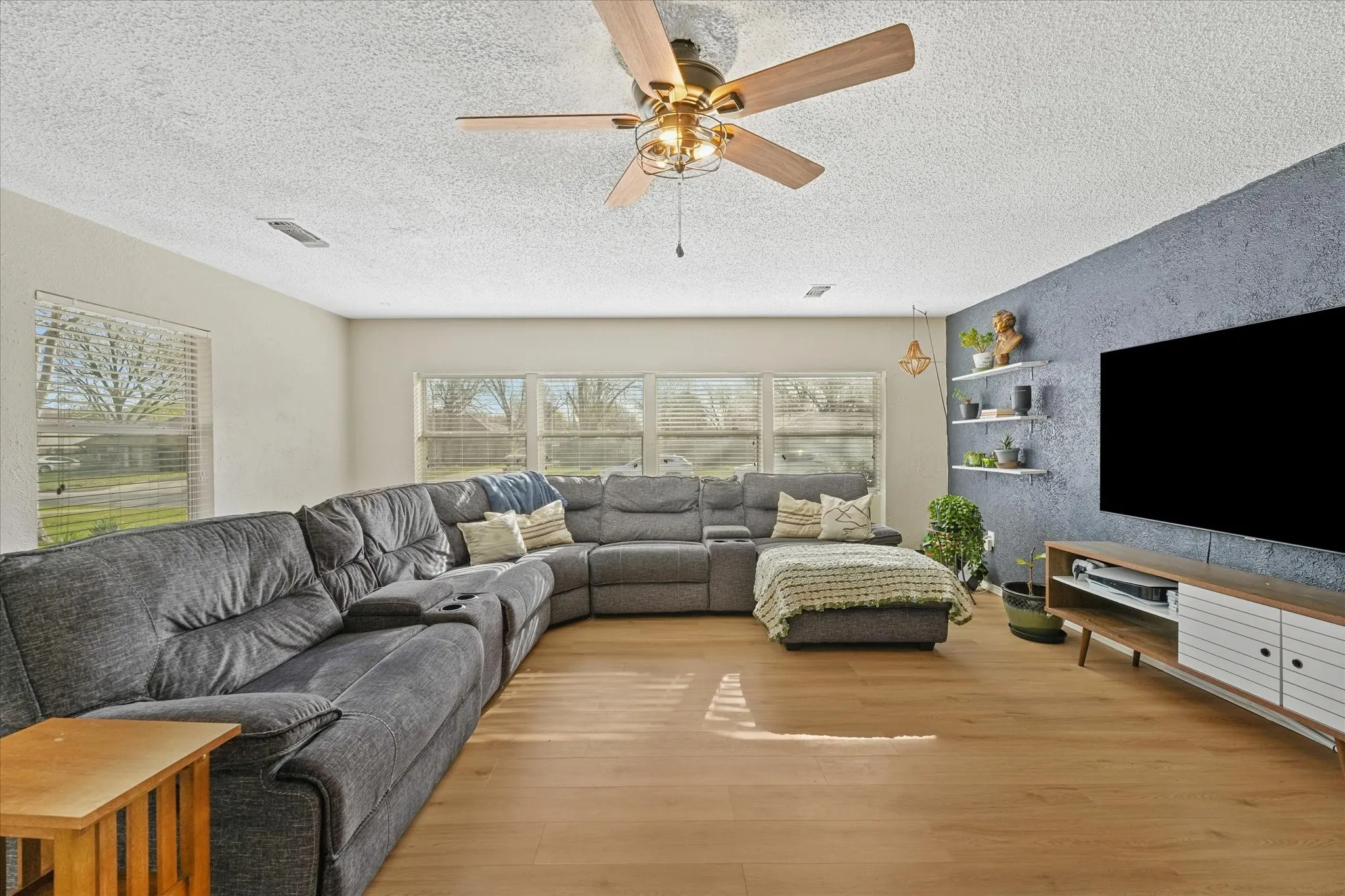 Updated living area with modern accent wall and open-concept feel connecting main living spaces.
