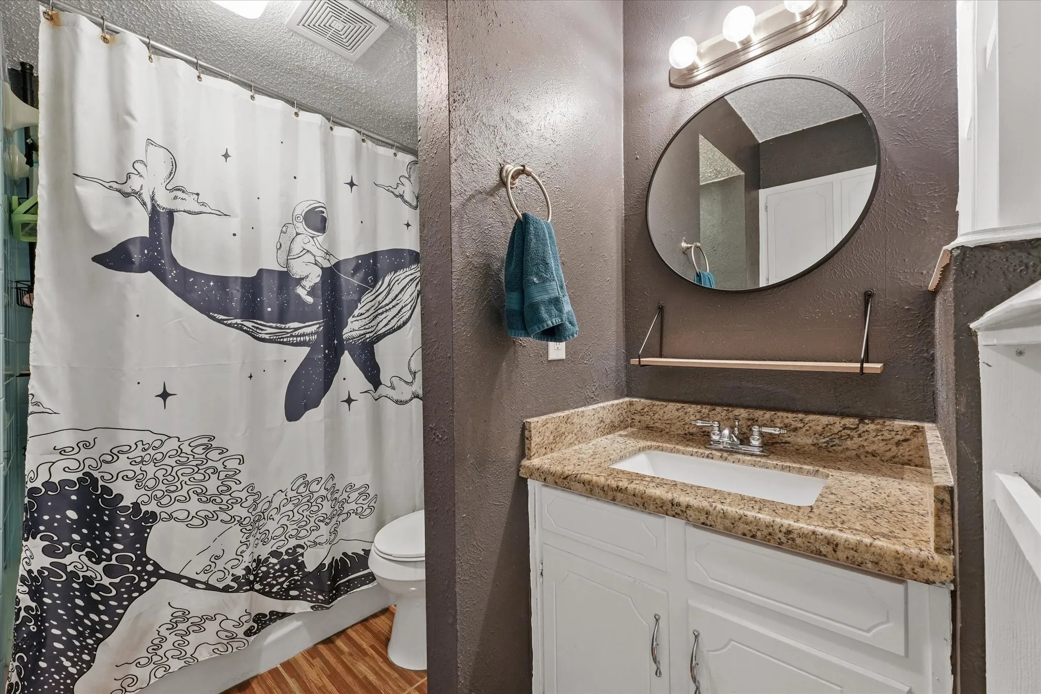 Full bathroom featuring granite countertops, updated vanity, and functional layout. Clean, well-maintained space with great potential for personalization.