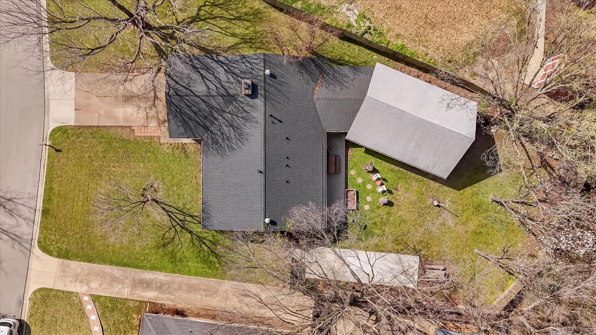 Aerial view showcasing the full property layout, including oversized lot, long driveway, backyard patio, and detached workshop. Plenty of space for outdoor living, storage, and future additions.
