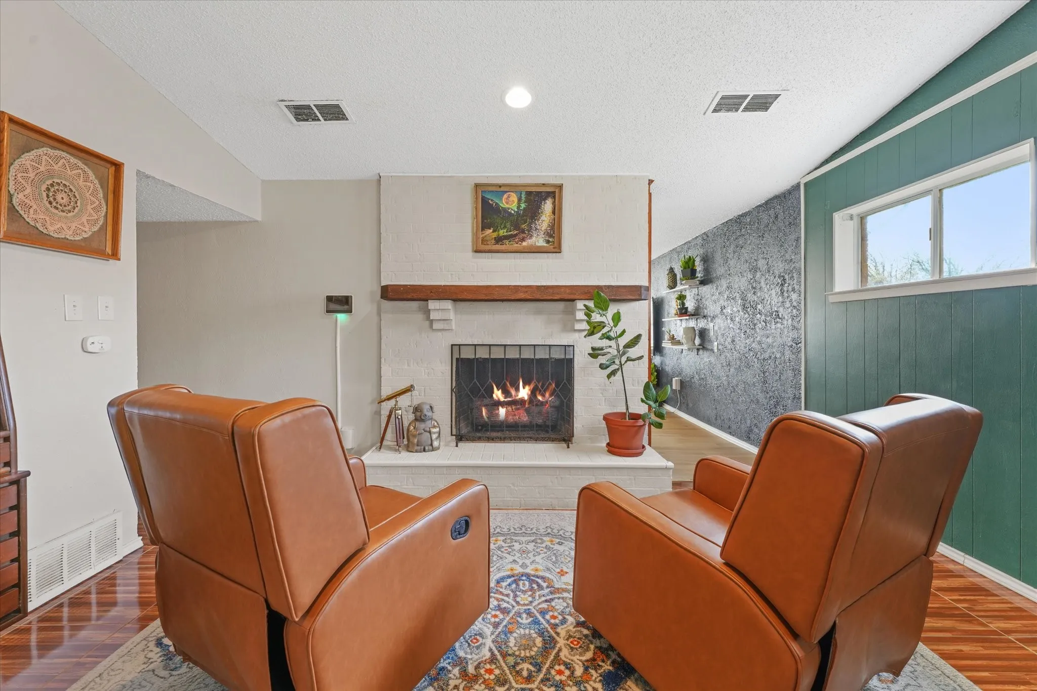 Second living area with wood-burning fireplace—perfect for cozy nights, media room, or additional entertaining space.