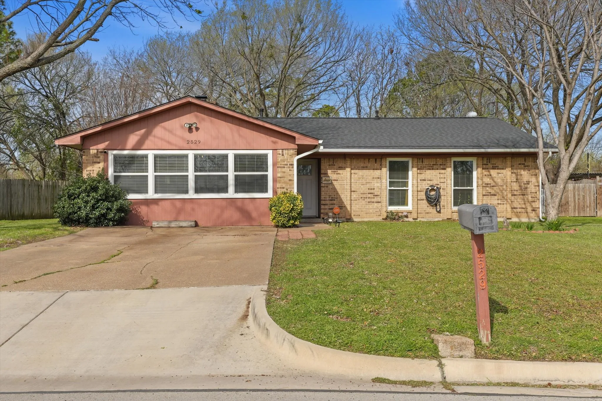 Wide driveway with ample parking space—great for multiple vehicles, guests, or work trucks.
