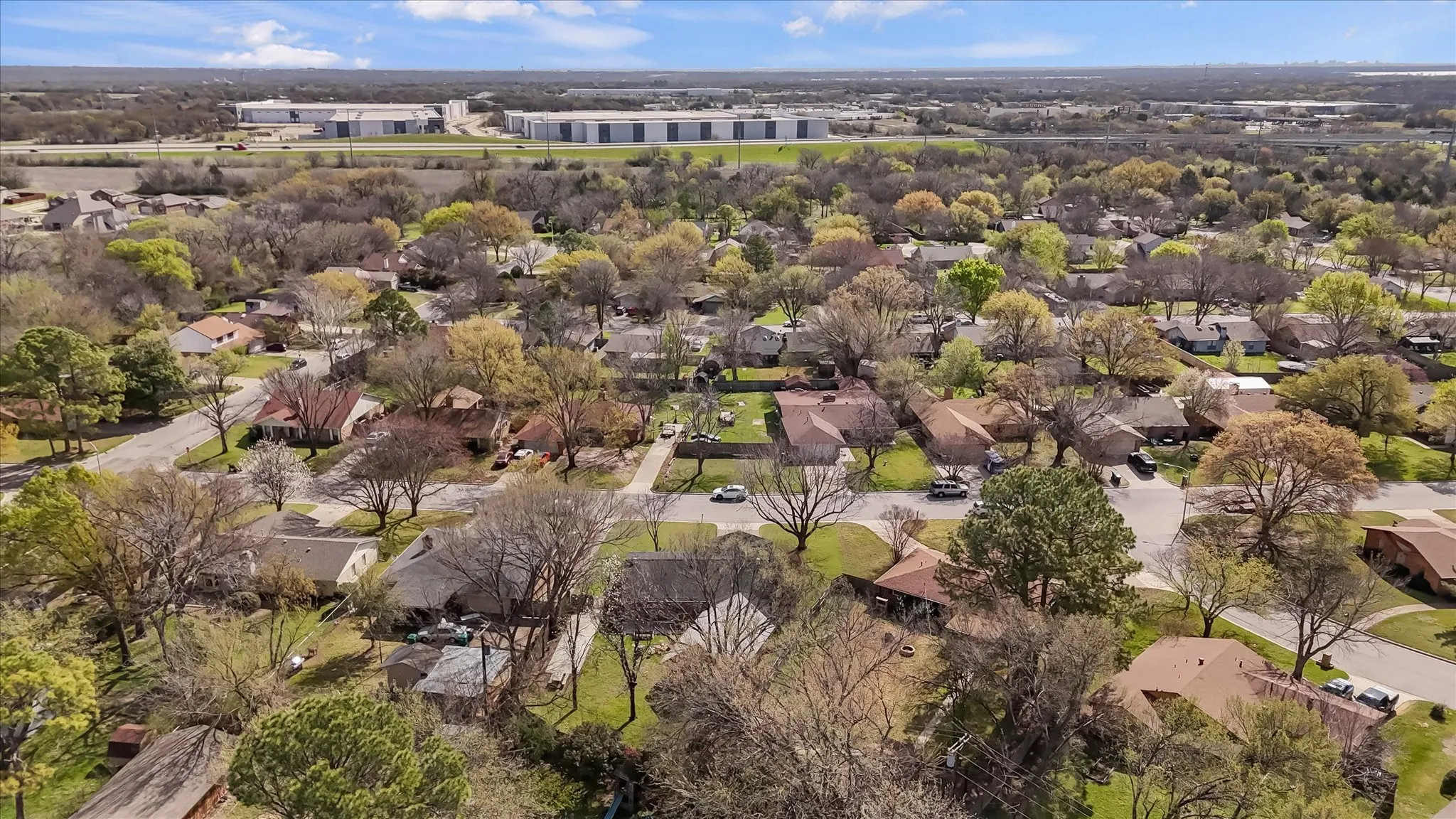 Aerial view showcasing the full property layout, including oversized lot, long driveway, backyard patio, and detached workshop. Plenty of space for outdoor living, storage, and future additions.