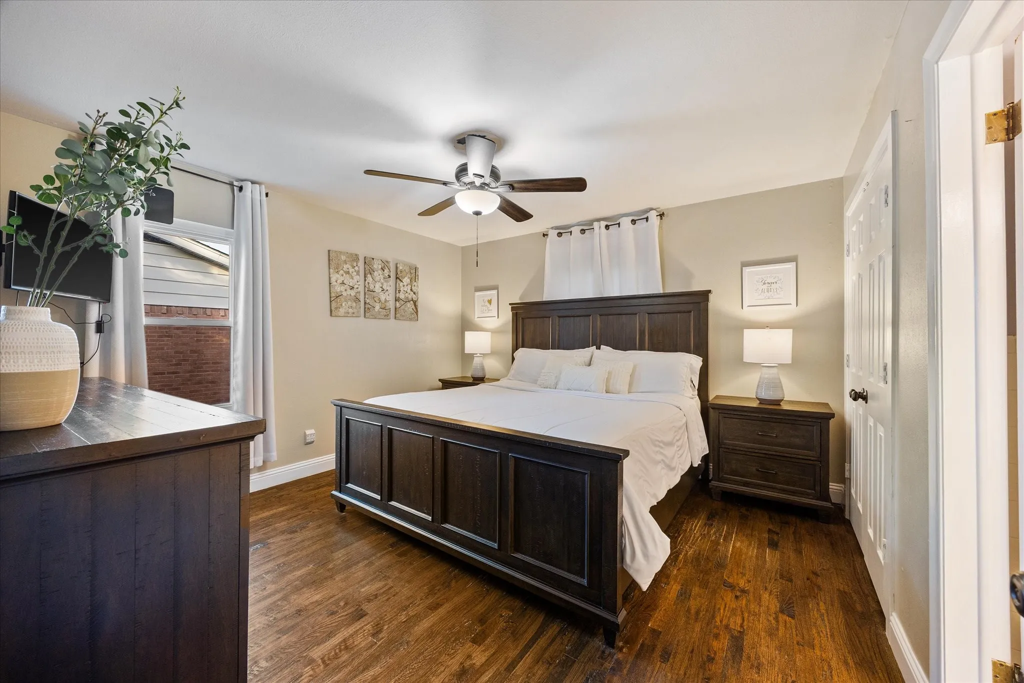 Bedroom with dark wood-style flooring and ceiling fan