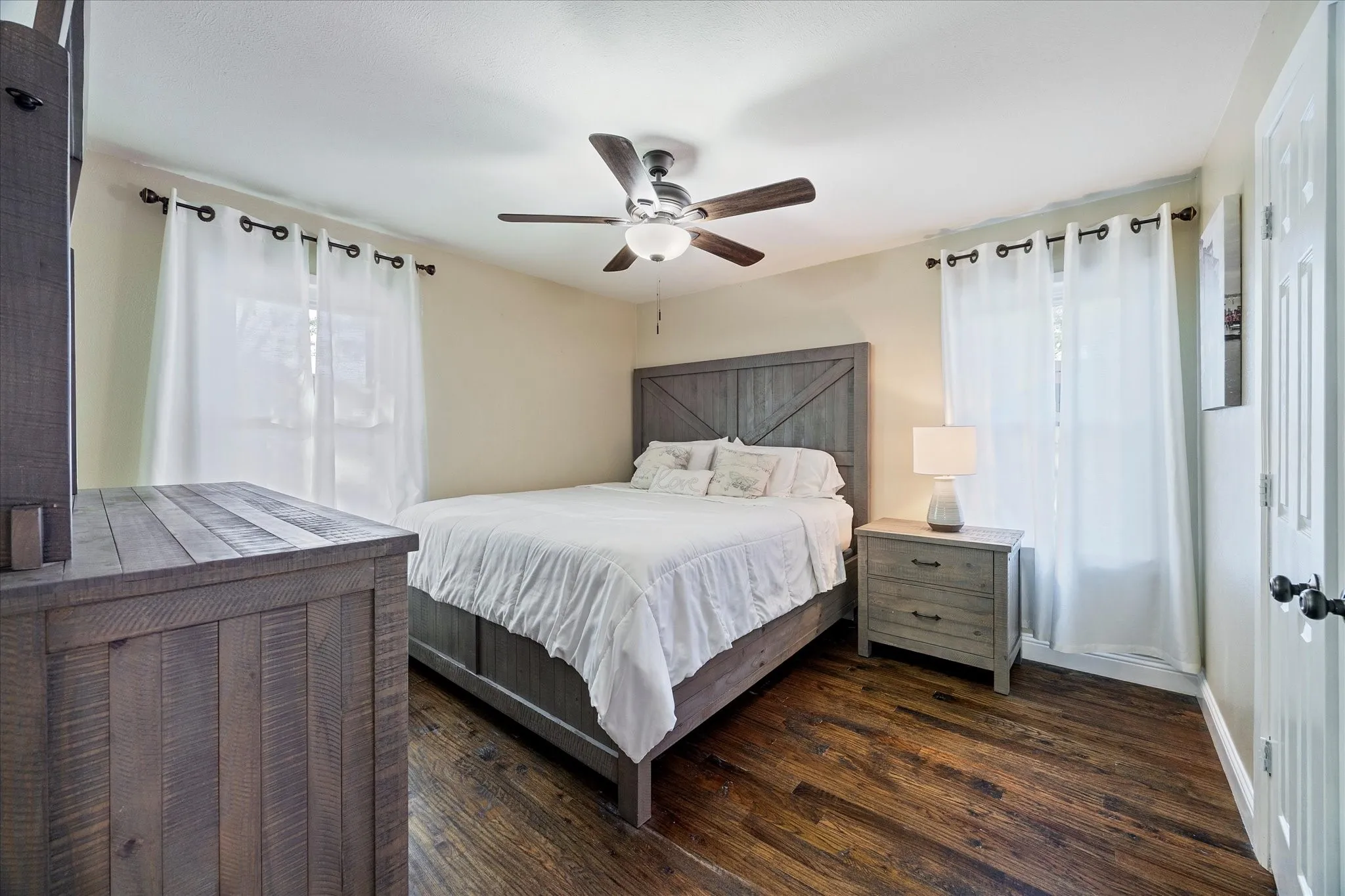 Bedroom featuring dark wood-type flooring and a ceiling fan