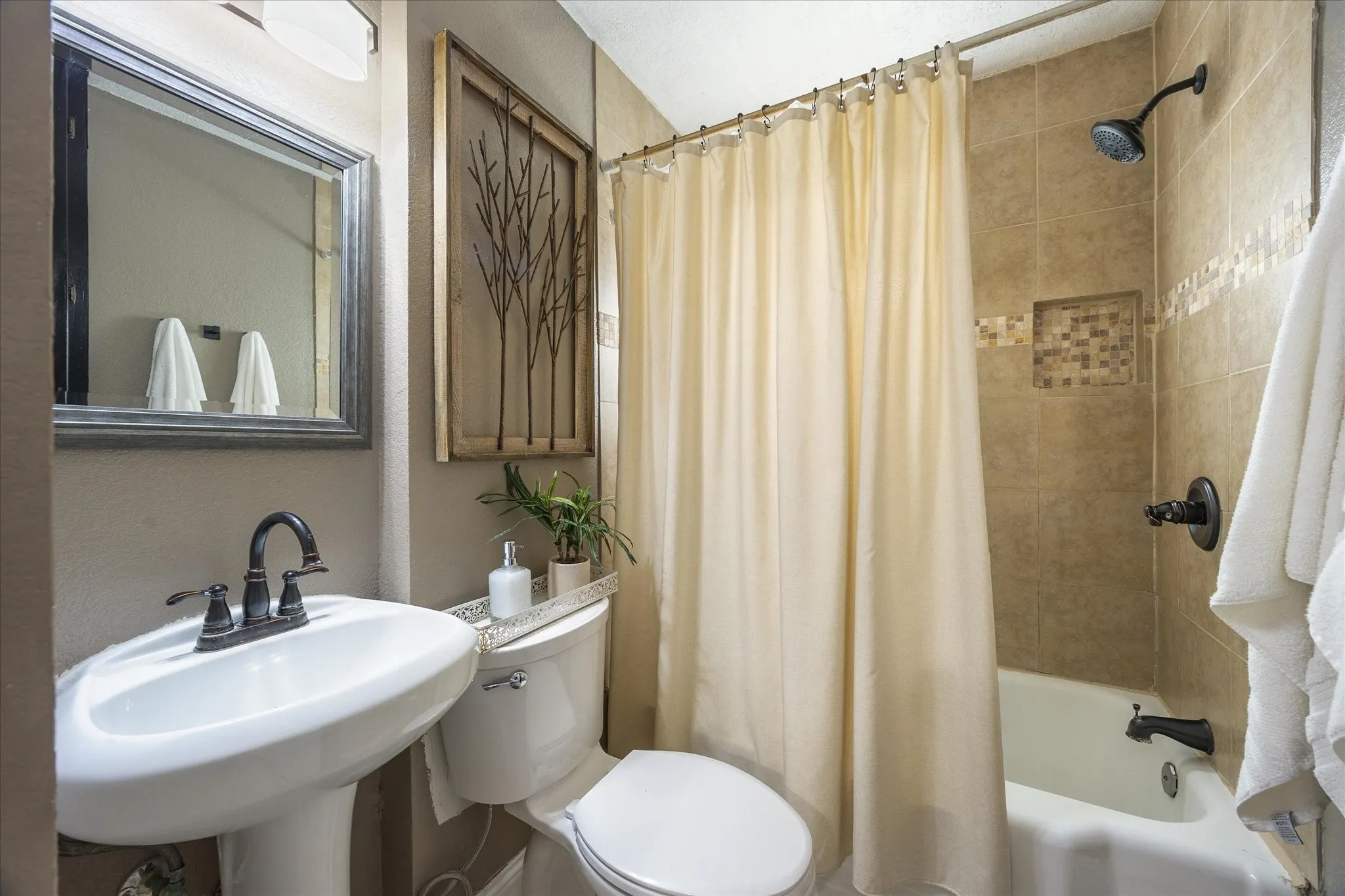 Bathroom featuring toilet and shower / bathtub combination with curtain