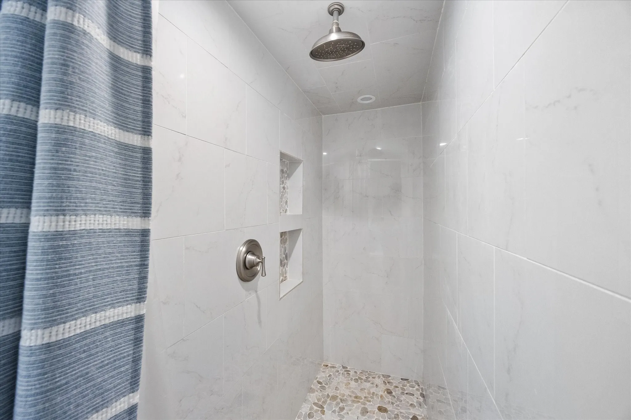 Bathroom with a marble finish shower