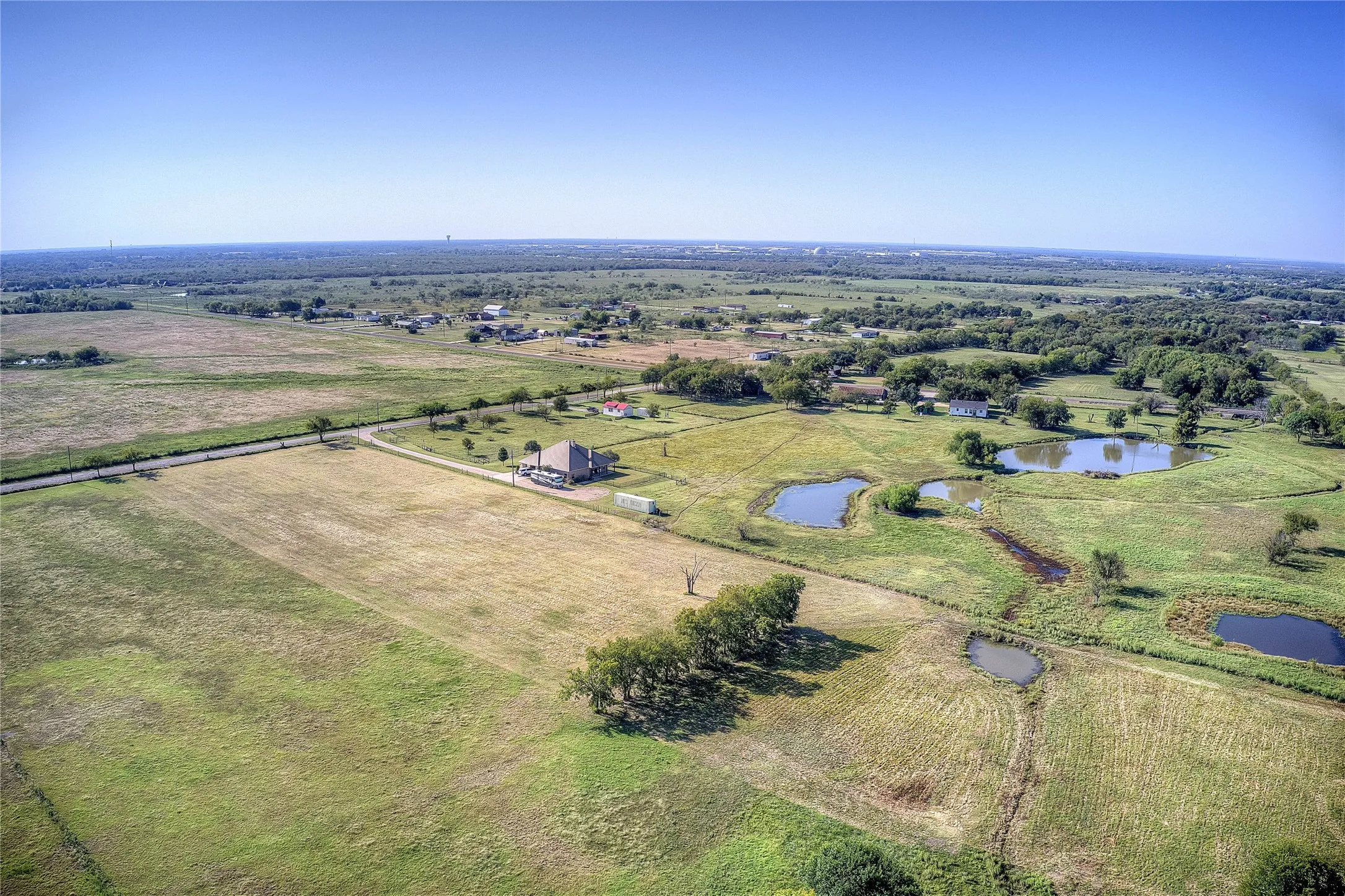 Aerial overview of property's location featuring rural landscape and a nearby body of water