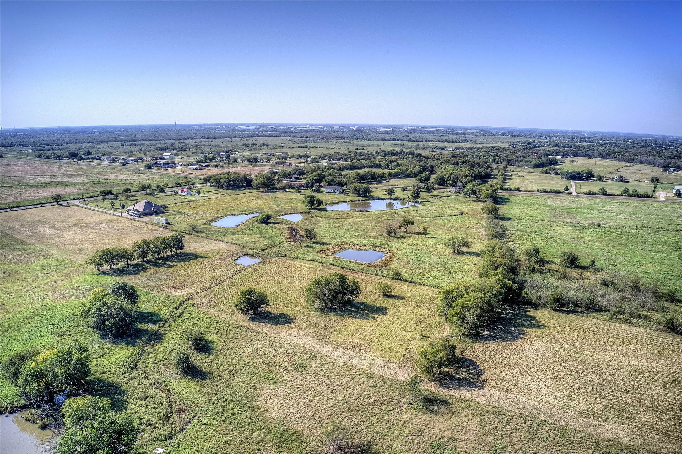 Overview of rural landscape featuring a nearby body of water