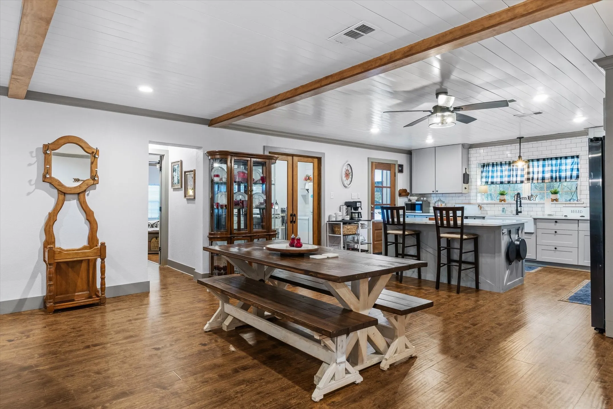 Dining space featuring beam ceiling, a ceiling fan, dark wood-type flooring, healthy amount of natural light, and recessed lighting