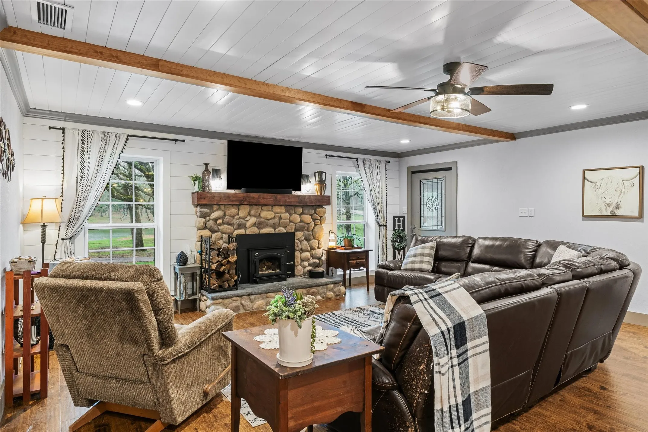 Living area featuring beam ceiling, wood finished floors, plenty of natural light, ceiling fan, and recessed lighting