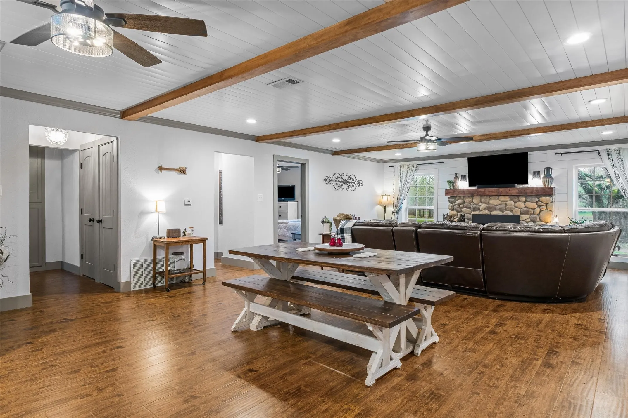 Dining area with ceiling fan, healthy amount of natural light, dark wood-style floors, beamed ceiling, and recessed lighting