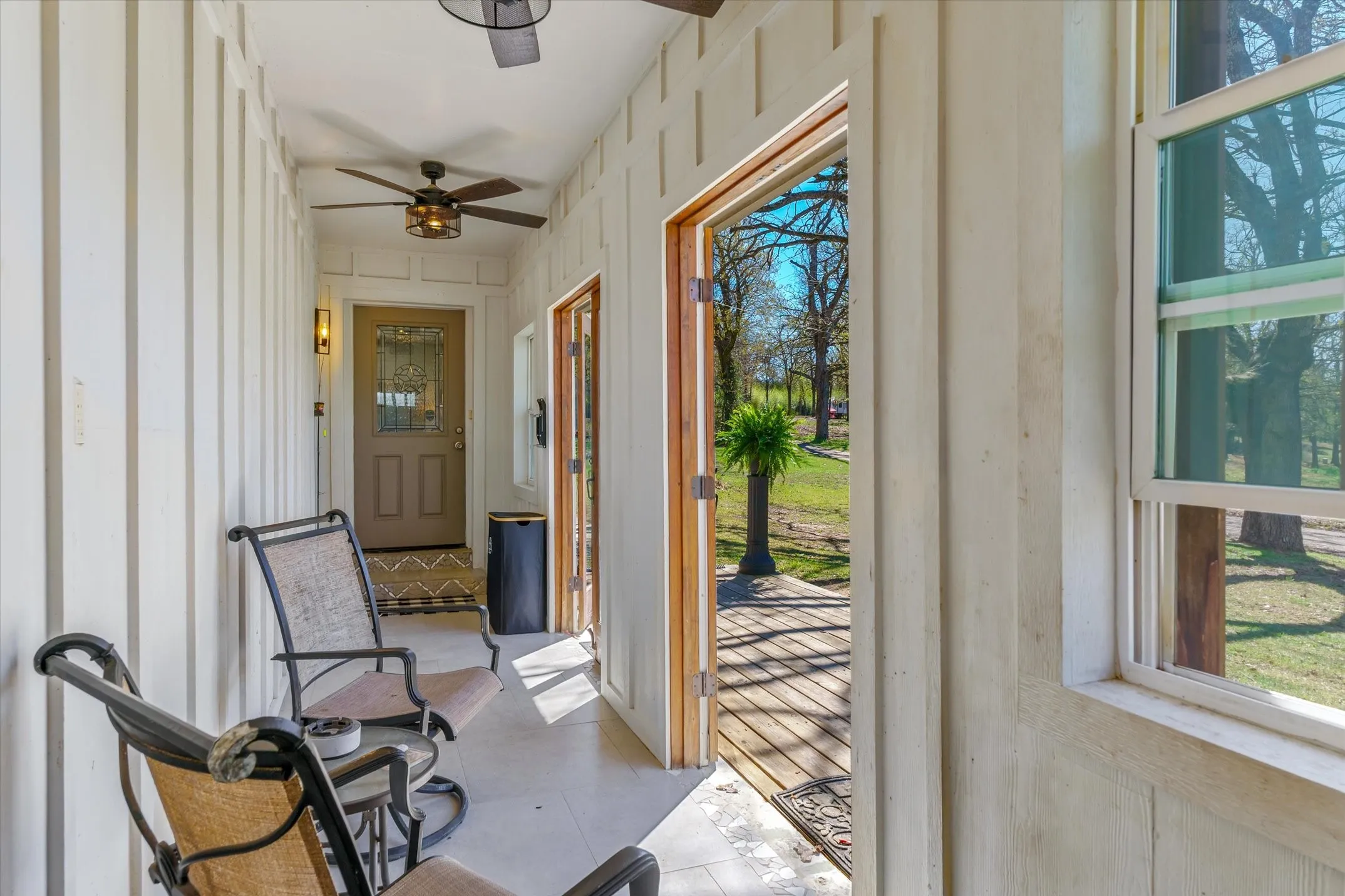 Enclosed side porch that has double doors to open so you can enjoy the view of neighboring pond