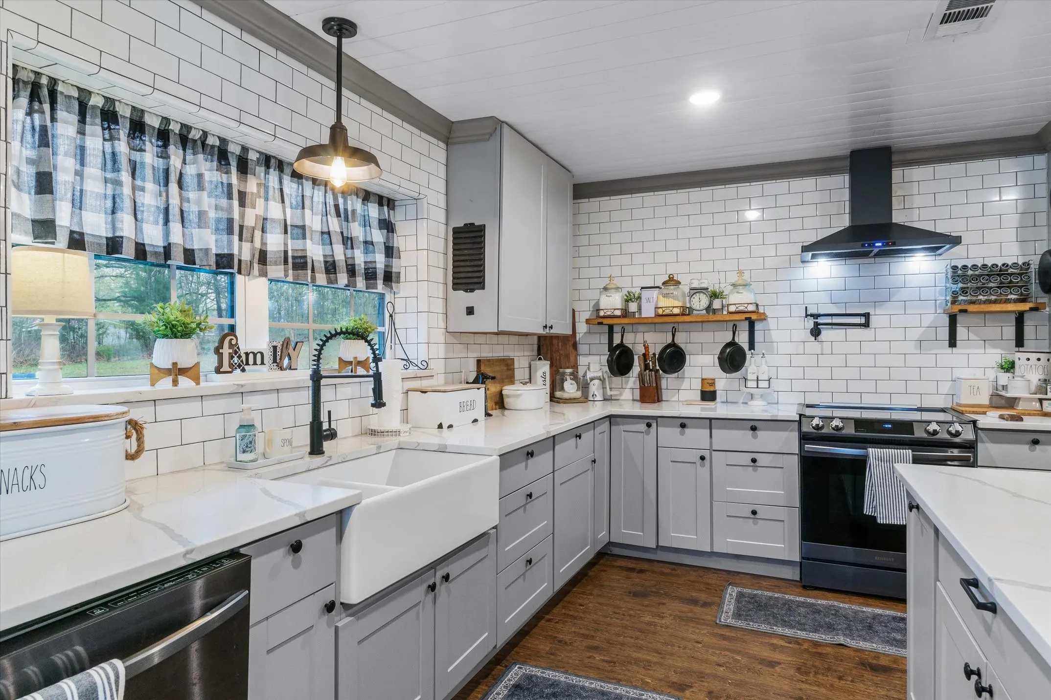 Kitchen with gray cabinetry, range with electric cooktop, open shelves, stainless steel dishwasher, and dark wood finished floors
