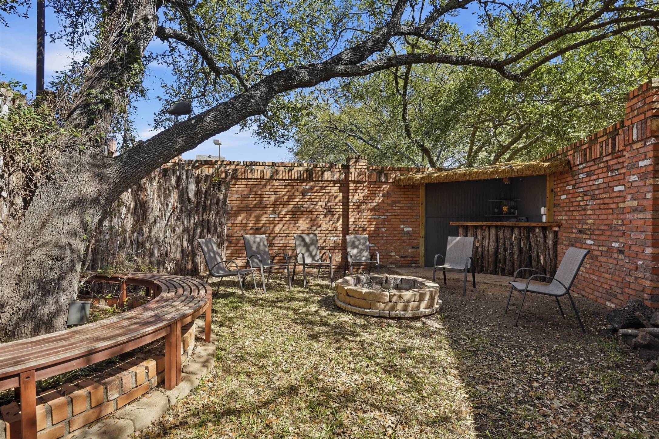 This is a private space outside with a bar and firepit.