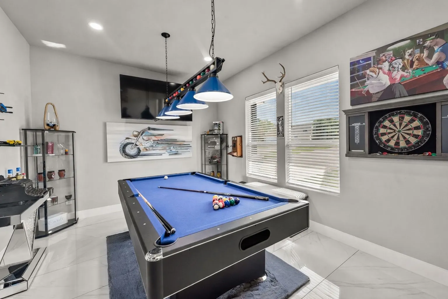 Game room with pool table, wall-mounted TV, and flexible space for entertaining guests.