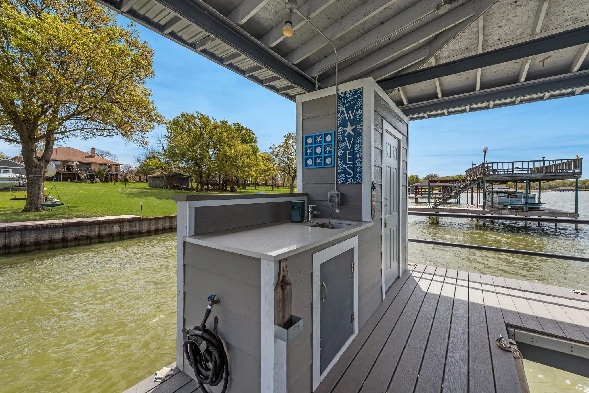 Dock cleanup station with sink, covered deck space, and waterfront convenience.