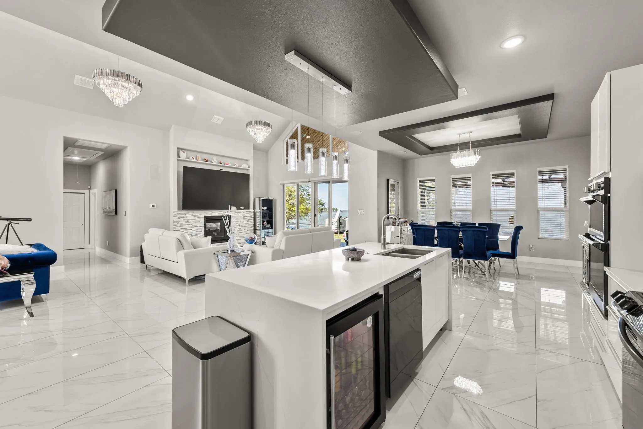 Spacious kitchen island with open sightlines to the living room and lake-facing windows.