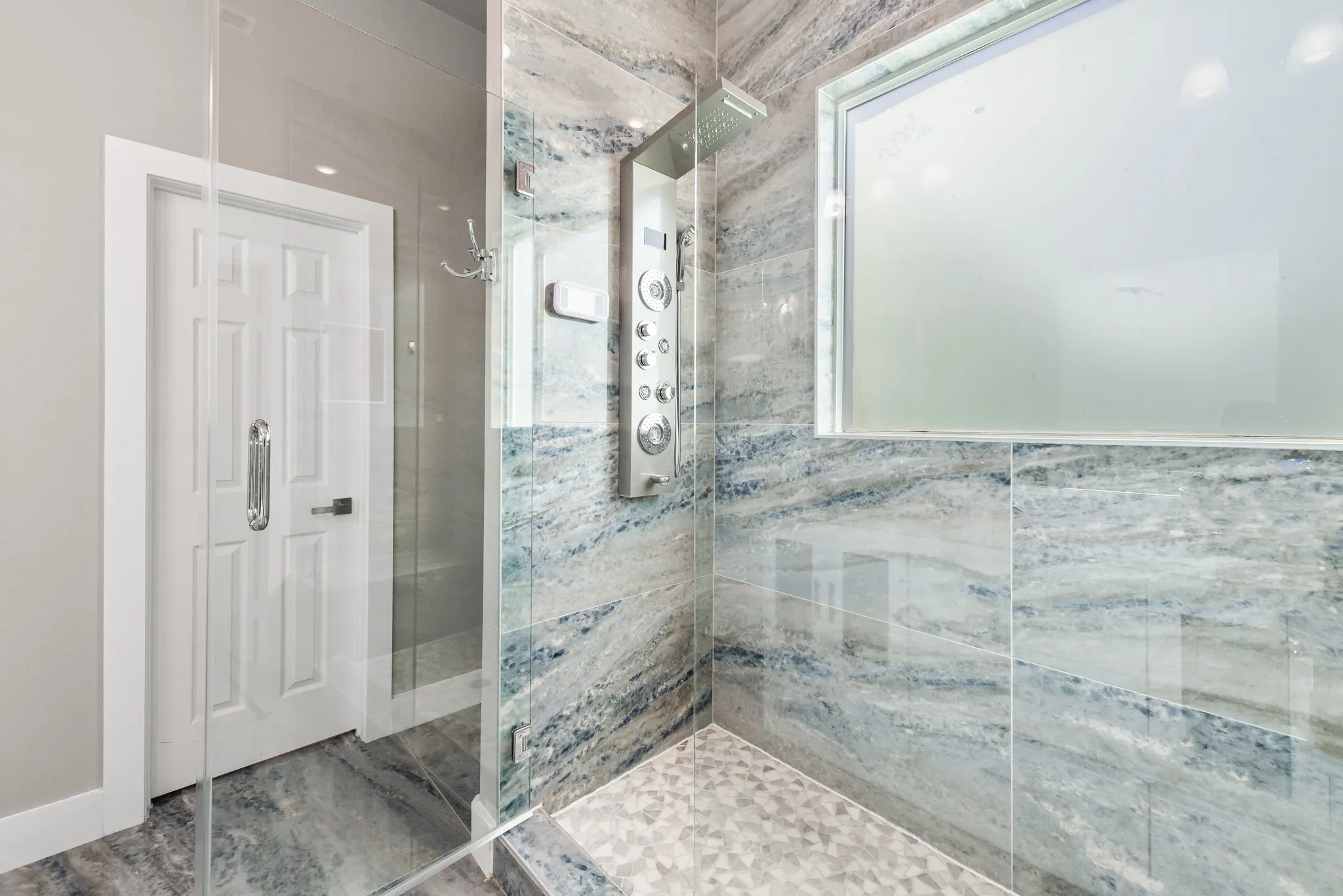Full bathroom with walk-in shower, tile accents, and clean modern design.