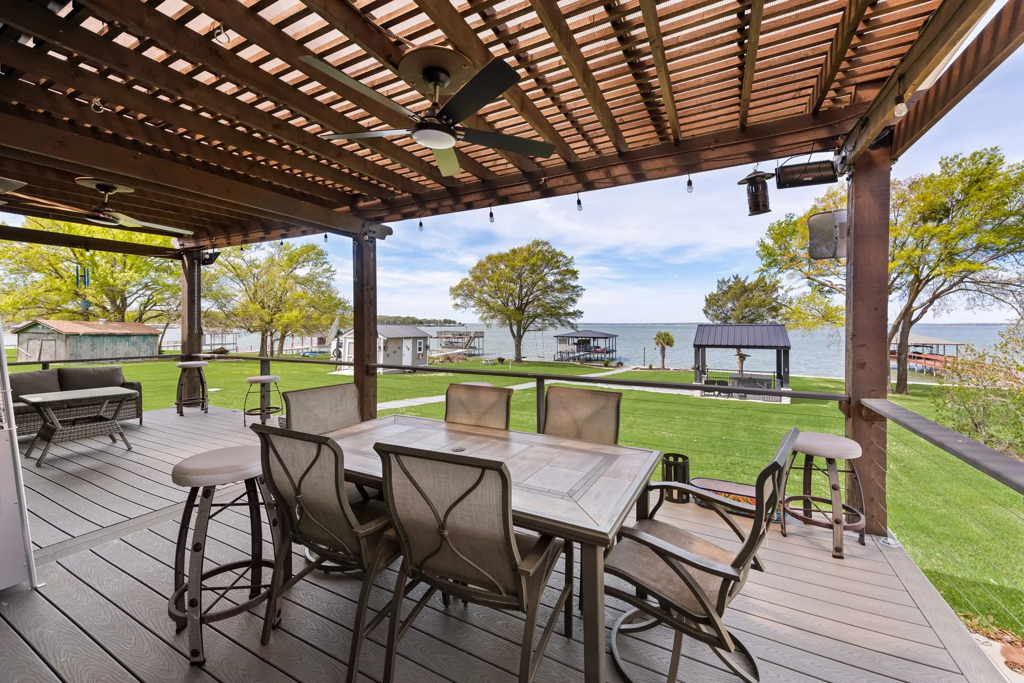 Pergola-covered patio overlooking the backyard and Richland Chambers Lake shoreline.