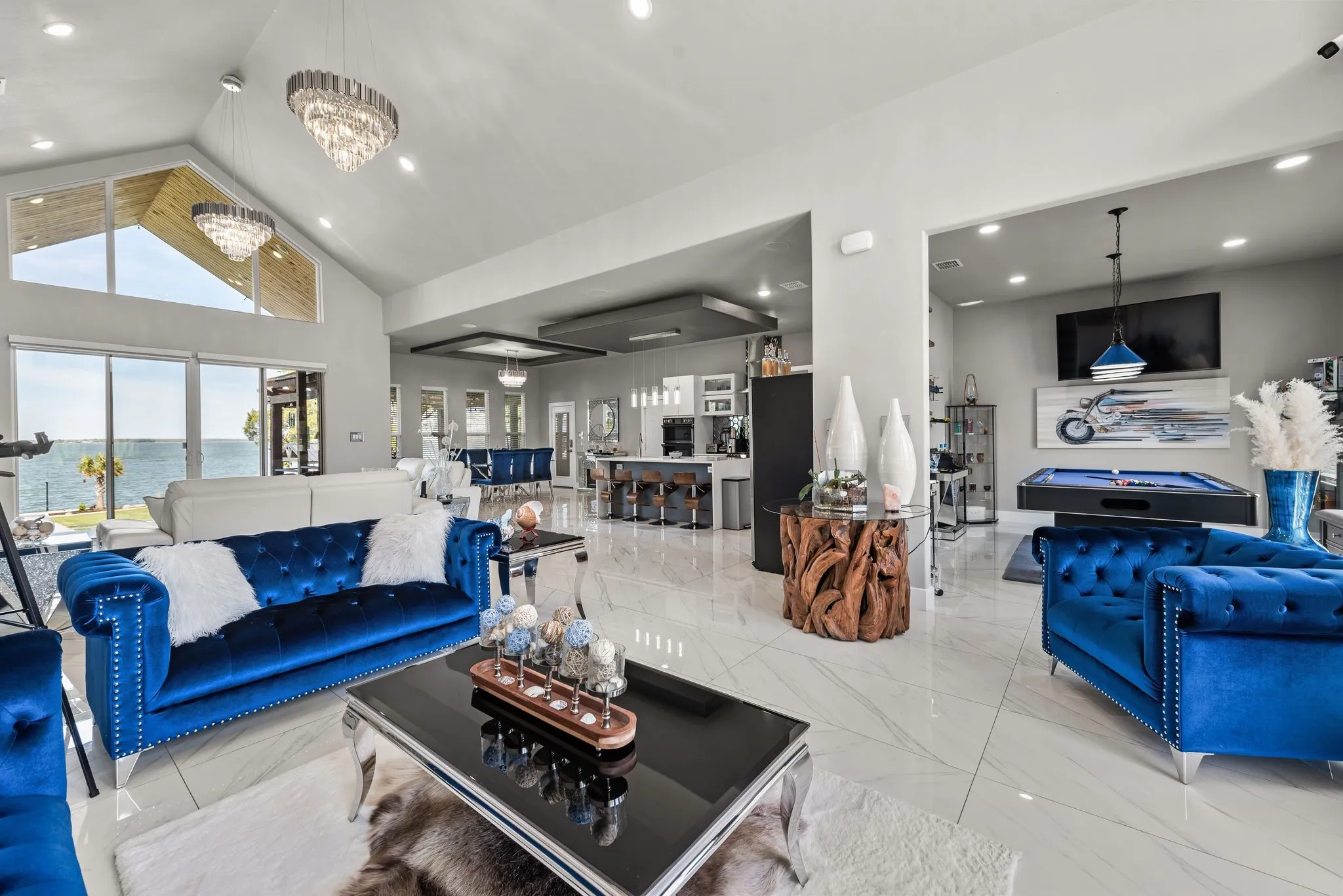 Open-concept living room with soaring ceilings, lake views, and modern lake house style.