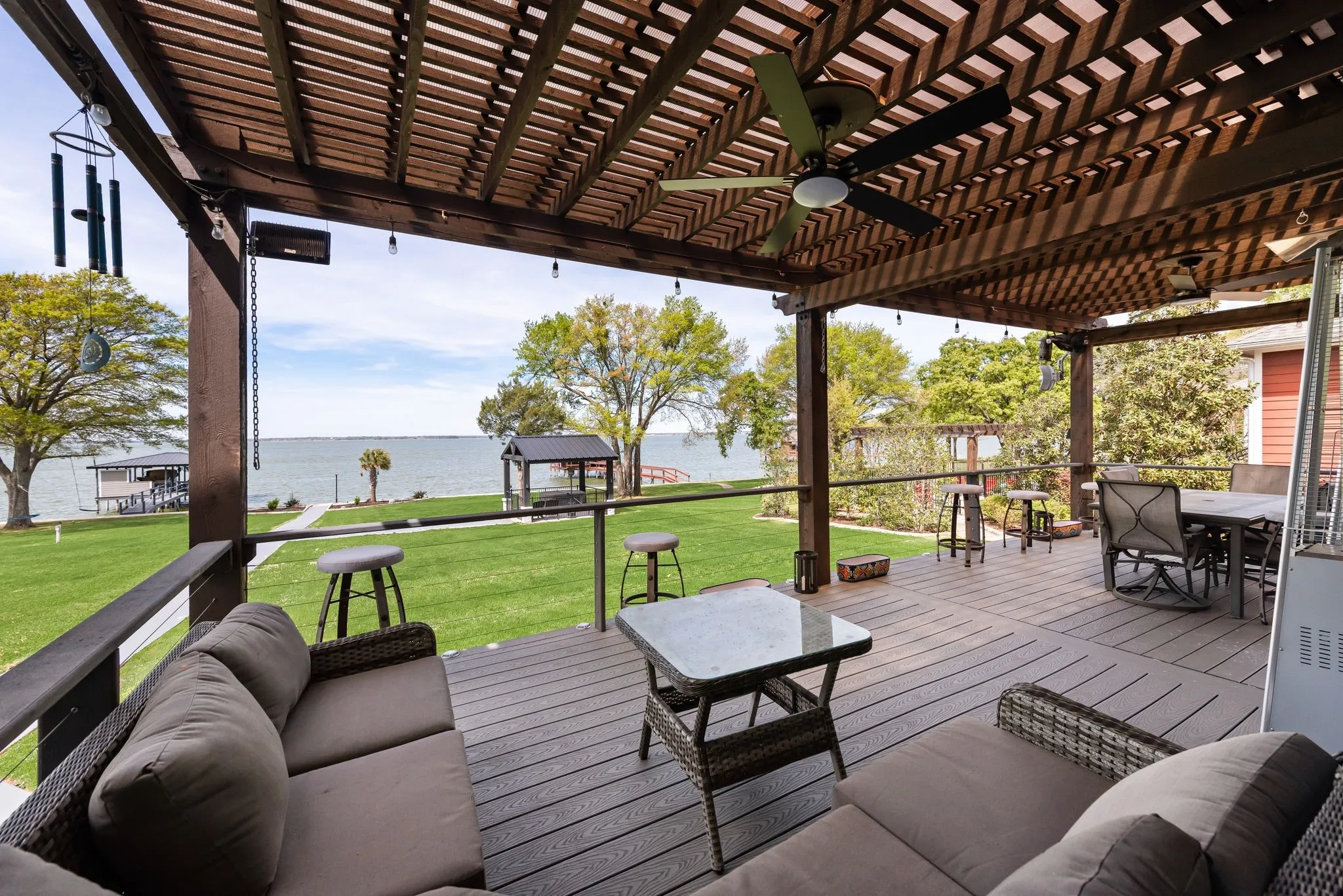 Covered outdoor seating area with lake views and room to relax in the shade.
