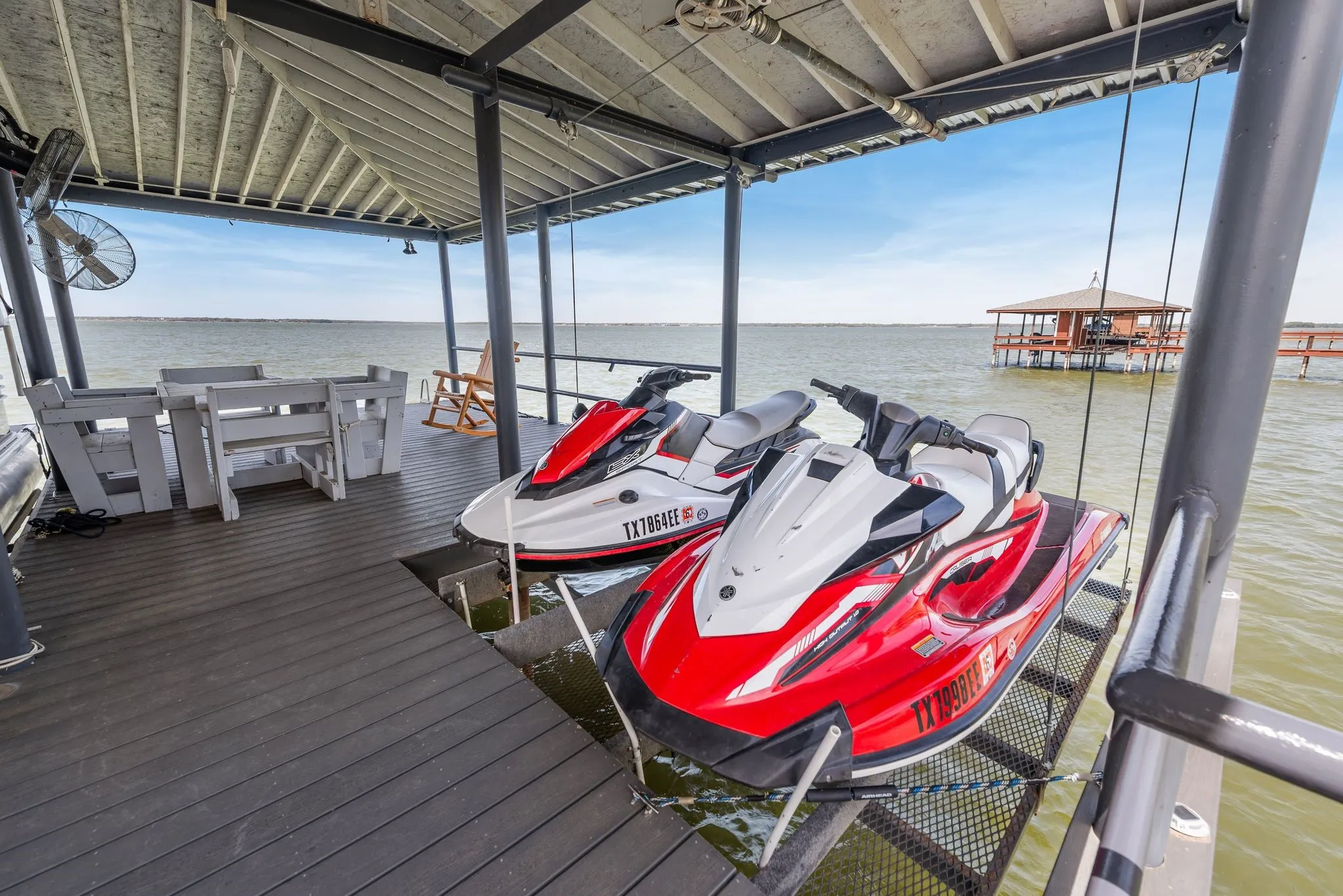 Covered dock with jet ski lifts, boat storage, and direct lake access.