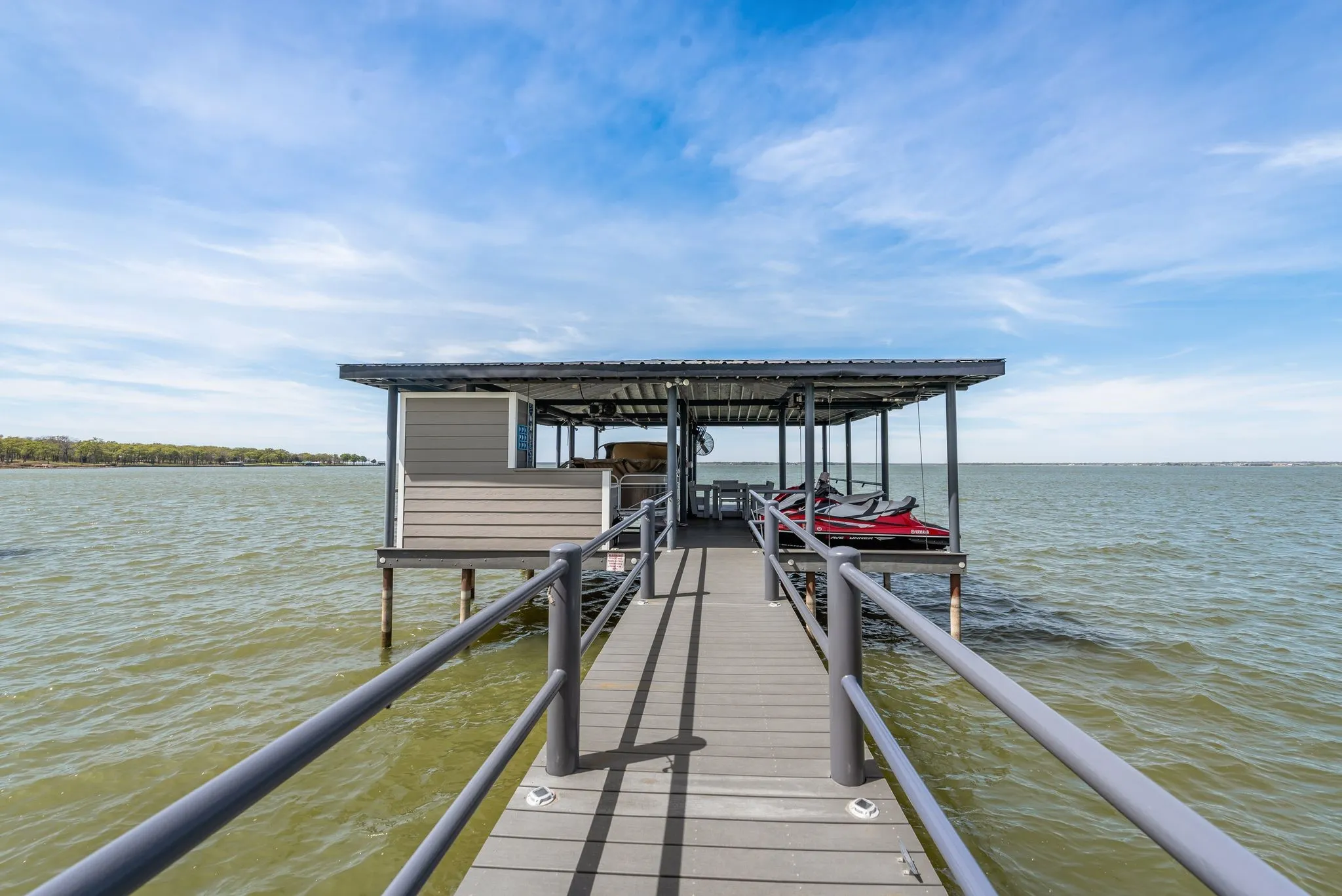 Private dock on Richland Chambers Lake with boat lift and dual jet ski lifts.