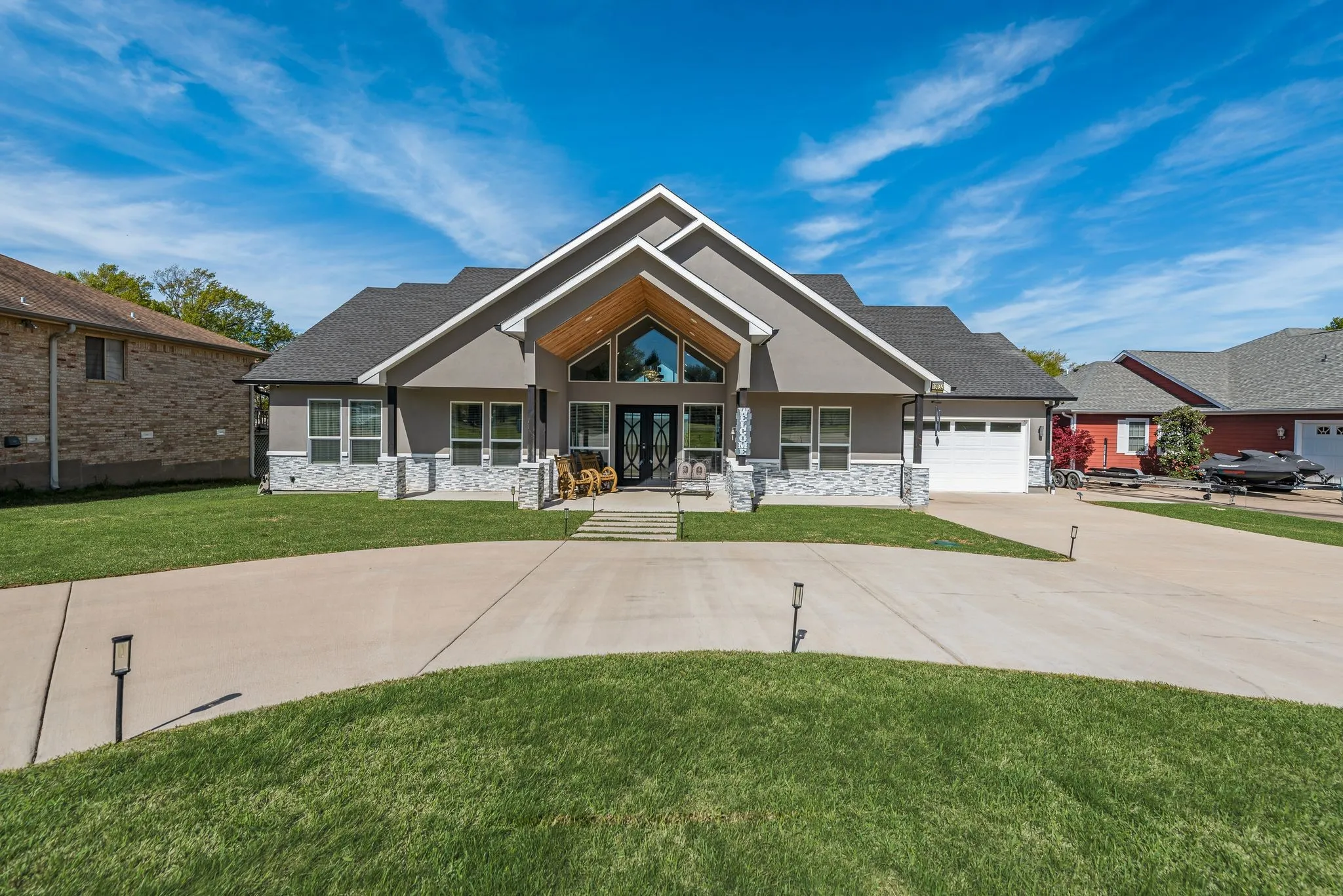Modern Craftsman lake house in Streetman, TX with dramatic gables and inviting curb appeal.