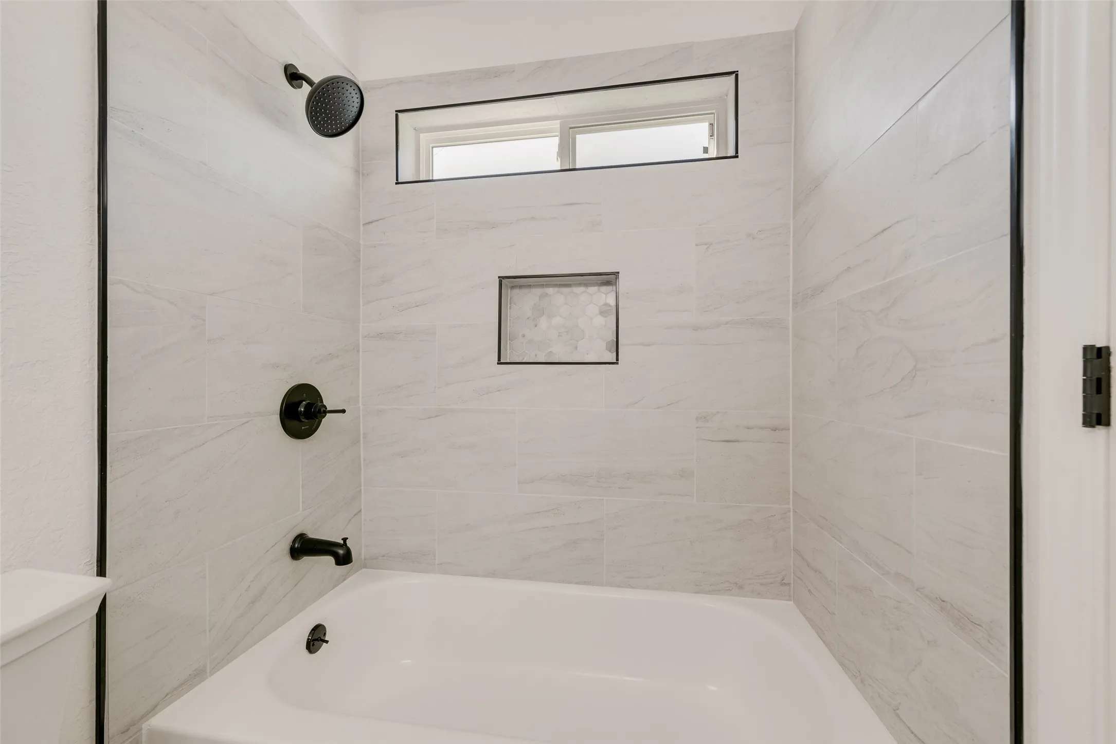 Full bathroom with toilet and shower / washtub combination
