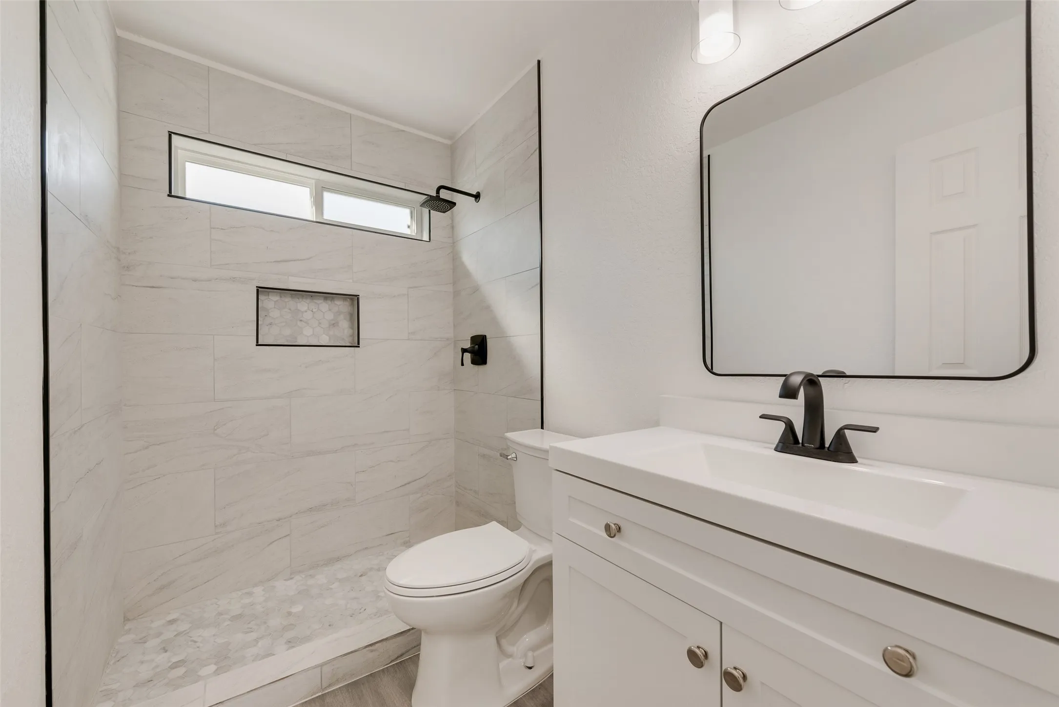 Bathroom with vanity and a stall shower