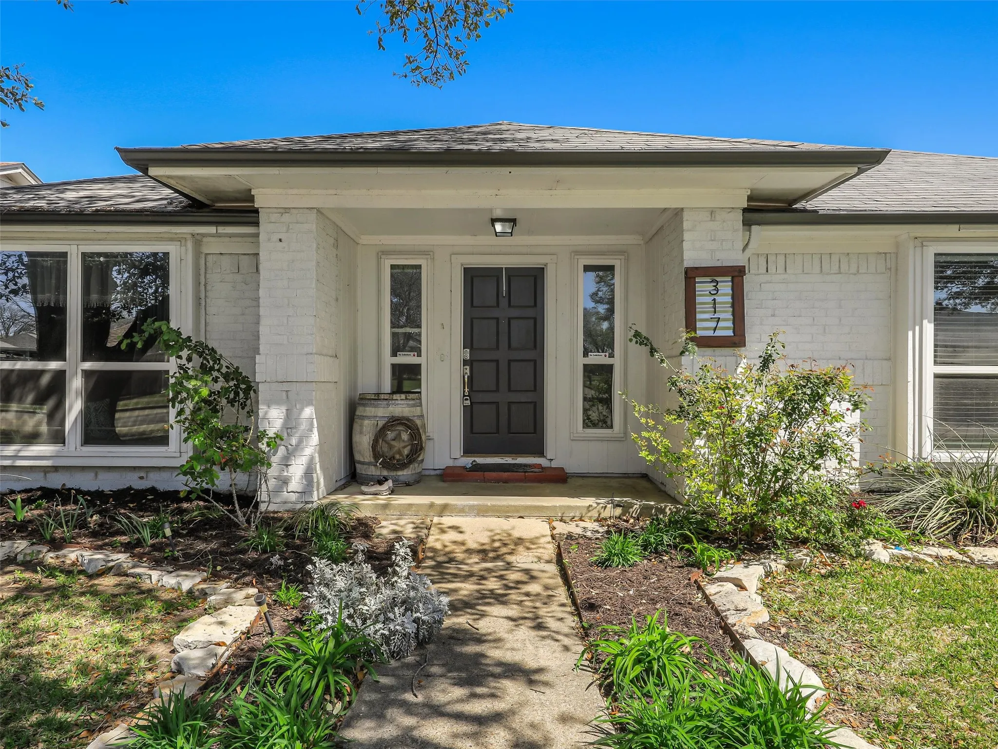 Step into a covered front porch framed by classic brickwork and clean landscaping. This inviting entry offers a comfortable transition into the home with space to personalize and make your own.