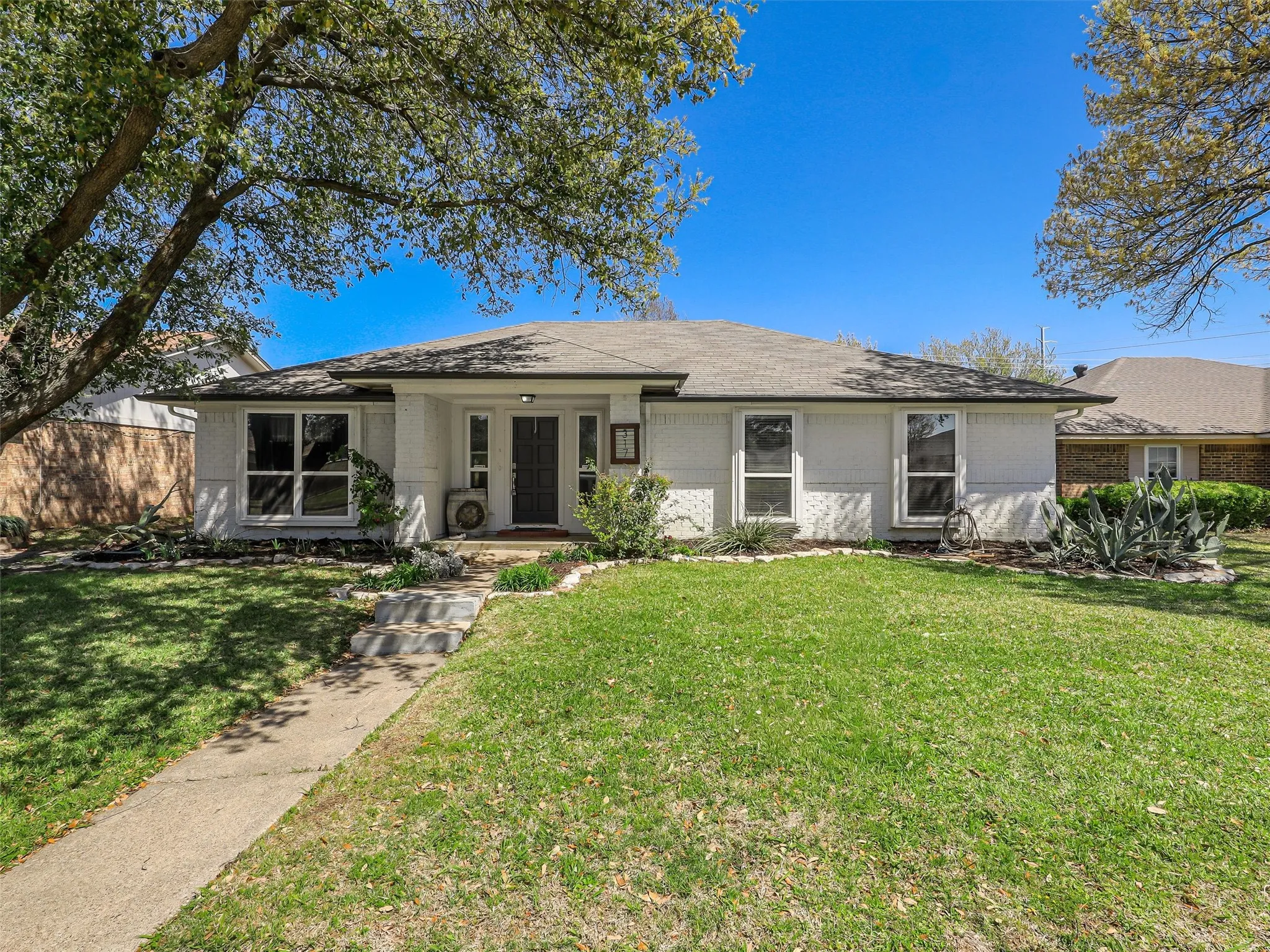 From the moment you arrive, there’s a sense of ease. Mature trees offer shade and character, while the welcoming front yard creates a space that feels both open and inviting. The walk to the front door sets the tone—this is a place you’ll look forward to coming home to.