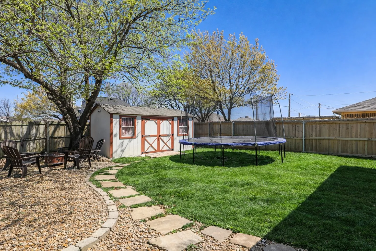 Step outside and discover a space designed for both relaxation and gathering. Mature trees provide shade and character, while the open yard offers room to unwind, entertain, or simply enjoy the outdoors at your own pace.
