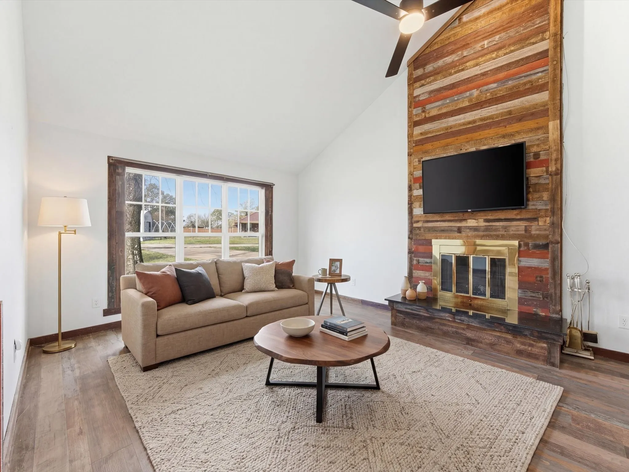 Kitchen featuring wood-finish flooring, white cabinetry, light-toned countertops, and a wood beam ceiling accent