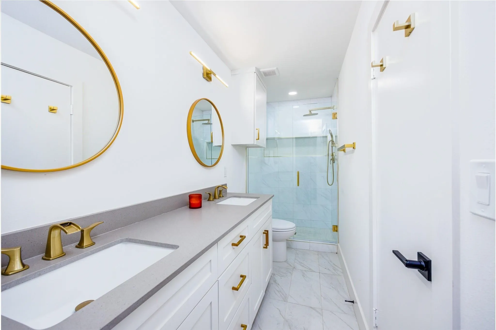 Remodeled bath with designer gold fixtures