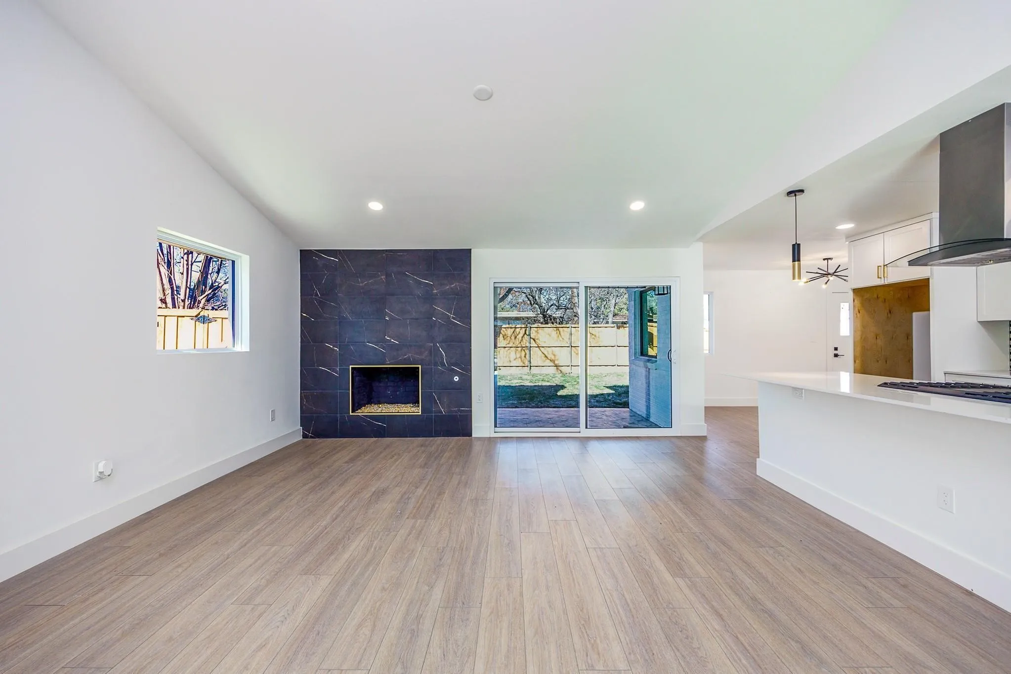 Living room with statement fireplace and new flooring throughout