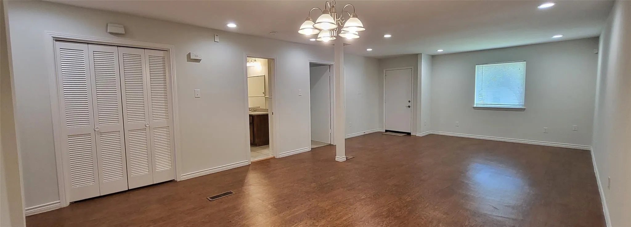 Spacious open living with hardwood-style floors